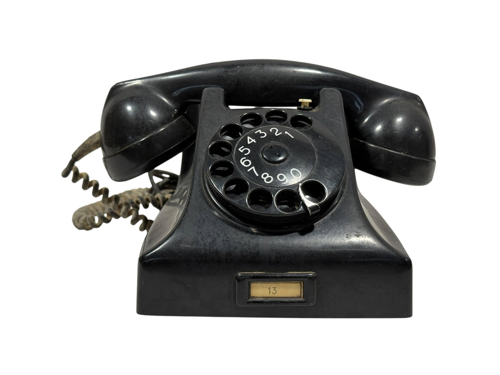 PTT Ericsson Black Bakelite Rotary Desk Telephone: Mid-century black Bakelite rotary desk telephone manufactured for the Dutch PTT (state postal and telecommunications service) and produced by Ericsson, retaining its original molded PTT logos and clas