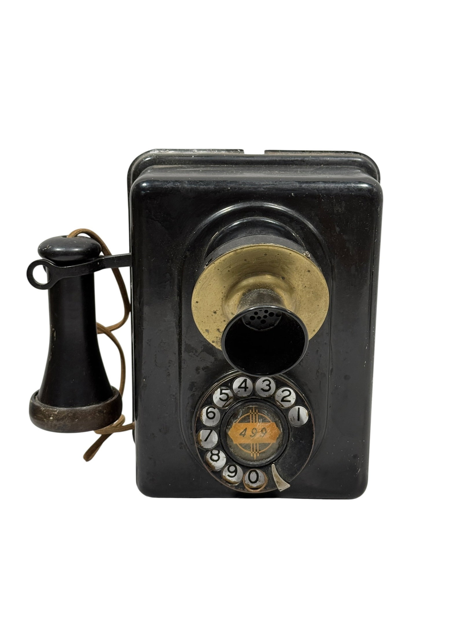 Early Wall-Mount Rotary Telephone Wall Unit: Early 20th century wall-mount telephone or intercom unit featuring a black japanned metal housing with integrated rotary dial, detachable earpiece receiver connected by an original cloth-covered cord,
