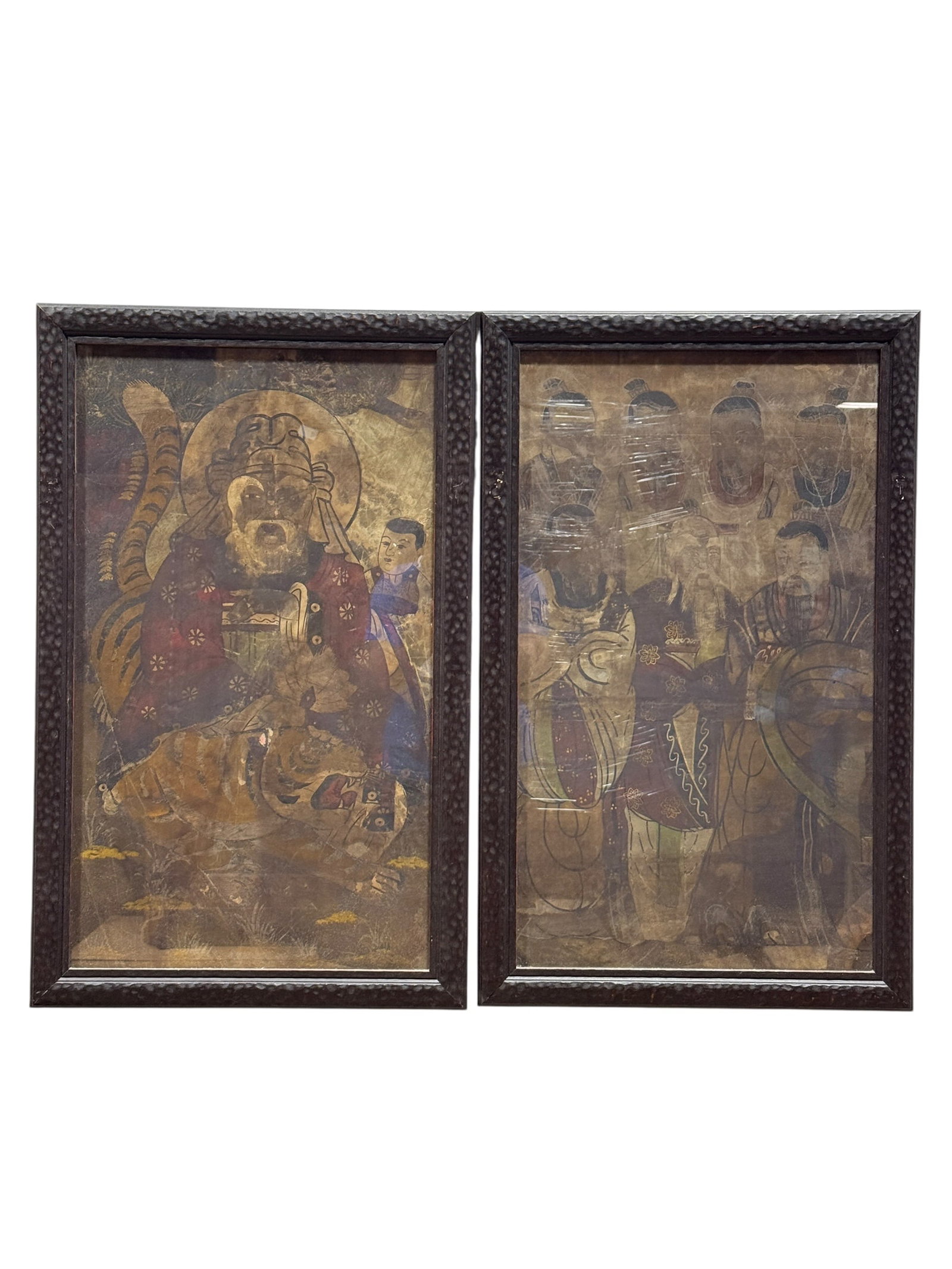 Pair of East Asian Religious Figural Paintings on Silk: A possibly antique pair of East Asian figural paintings on silk depicting religious or ceremonial figures rendered in muted earth tones with gilt accents. One panel portrays a haloed bearded figure se