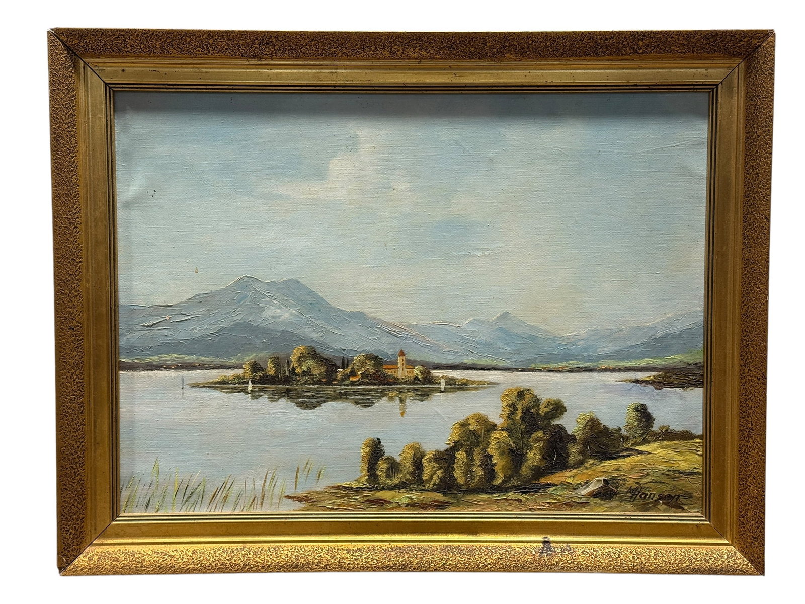 Signed Hansen 20th Century European Landscape Oil on Canvas: 20th century oil on canvas depicting a serene European alpine landscape centered on the picturesque island of Fraueninsel on Lake Chiemsee, with its historic church rising above a cluster of mature tr