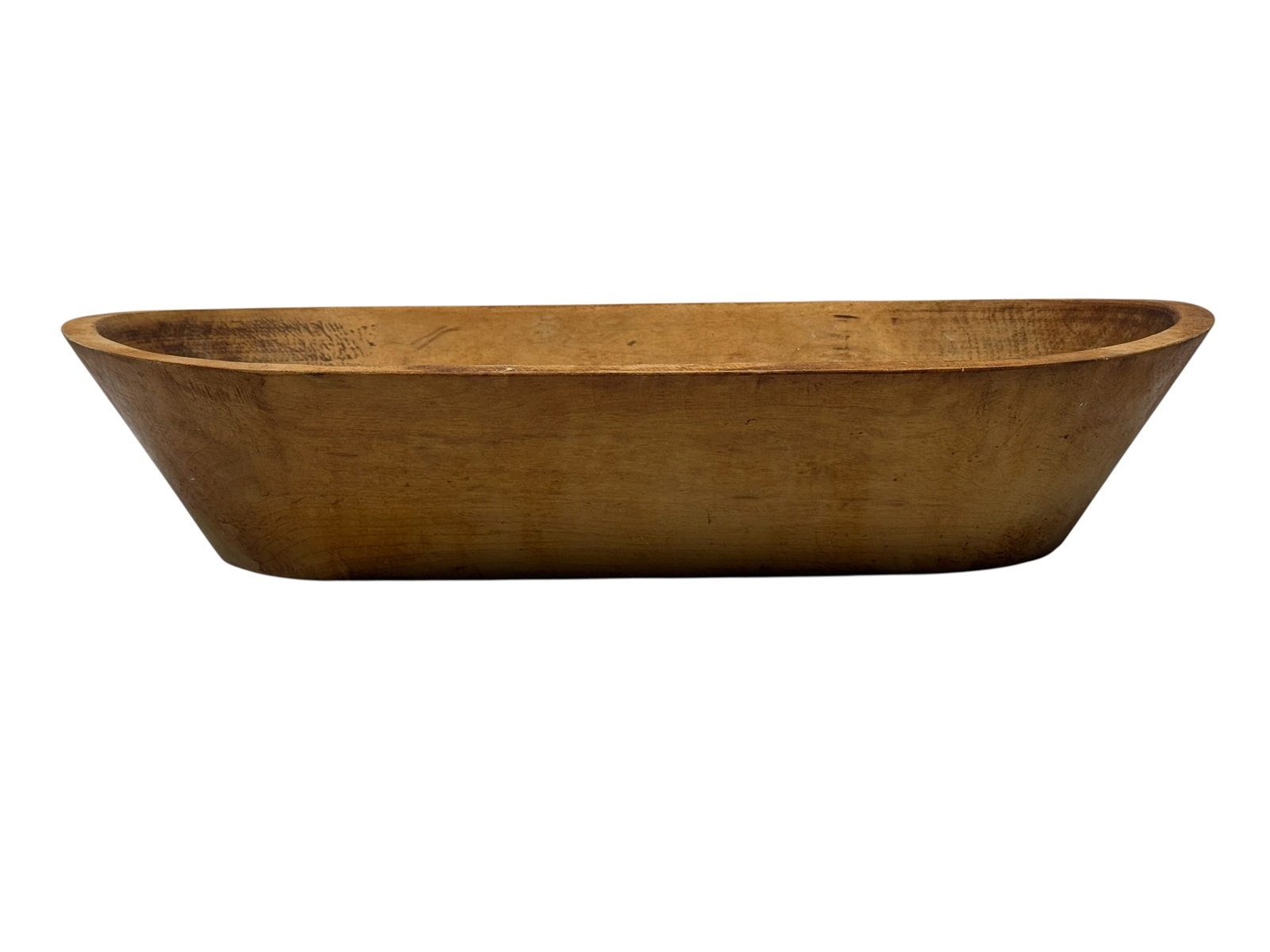 19th Century American Hand-Carved Dough Bowl: 19th century American hand-carved hardwood dough bowl of elongated oval form with gracefully tapered ends and a warm honey-toned patina. Hewn from a single solid block, this substantial primitive bowl
