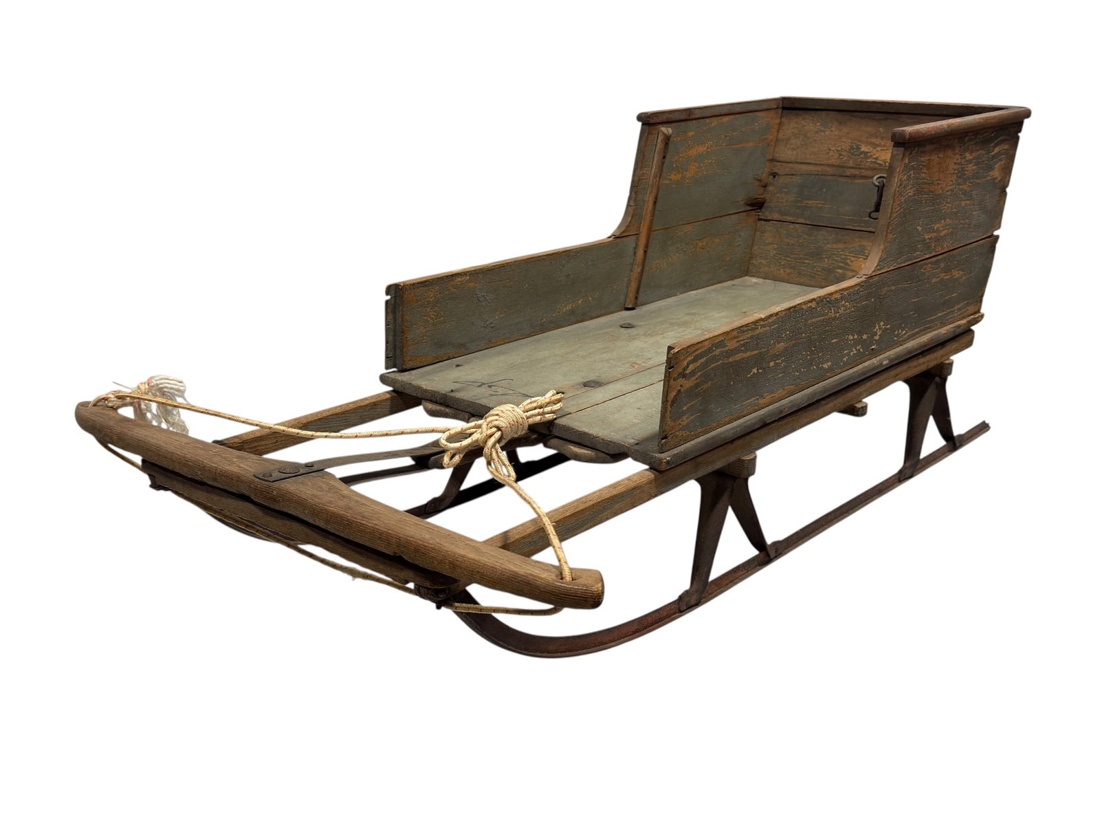 Primitive Painted Wood Sleigh: A charming primitive painted wood sleigh featuring a hand-built plank body with its original weathered green-painted surface displaying attractive natural patina and age. The sleigh is mounted on hand