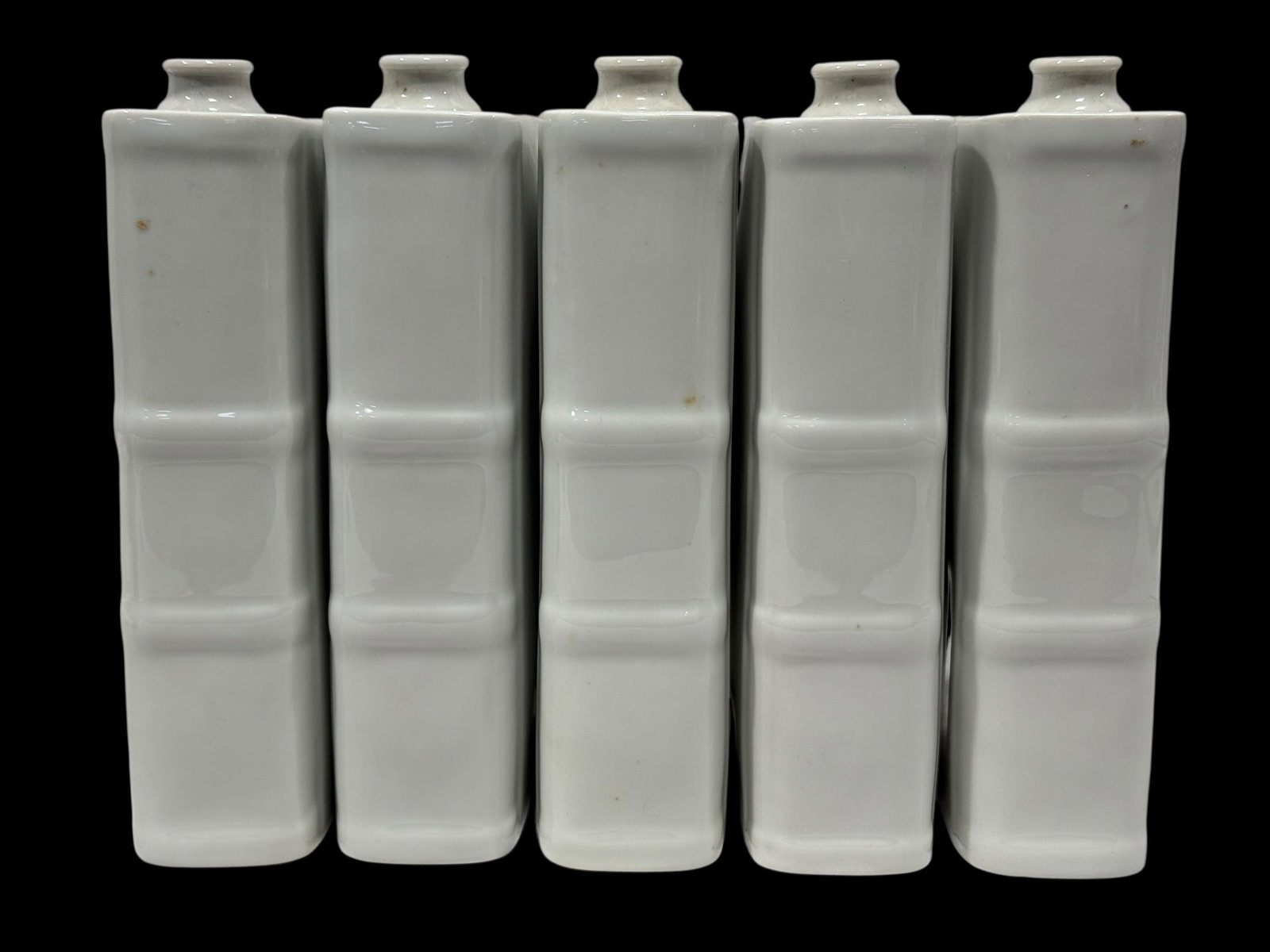 (5) Vintage French Limoges White Glazed Porcelain Book-Form Flasks: An unusual and highly decorative set of five vintage French porcelain book-form pocket flasks or book vases, attributed to Limoges, finished in a clean, high-gloss white glaze. Each flask is cleverly 