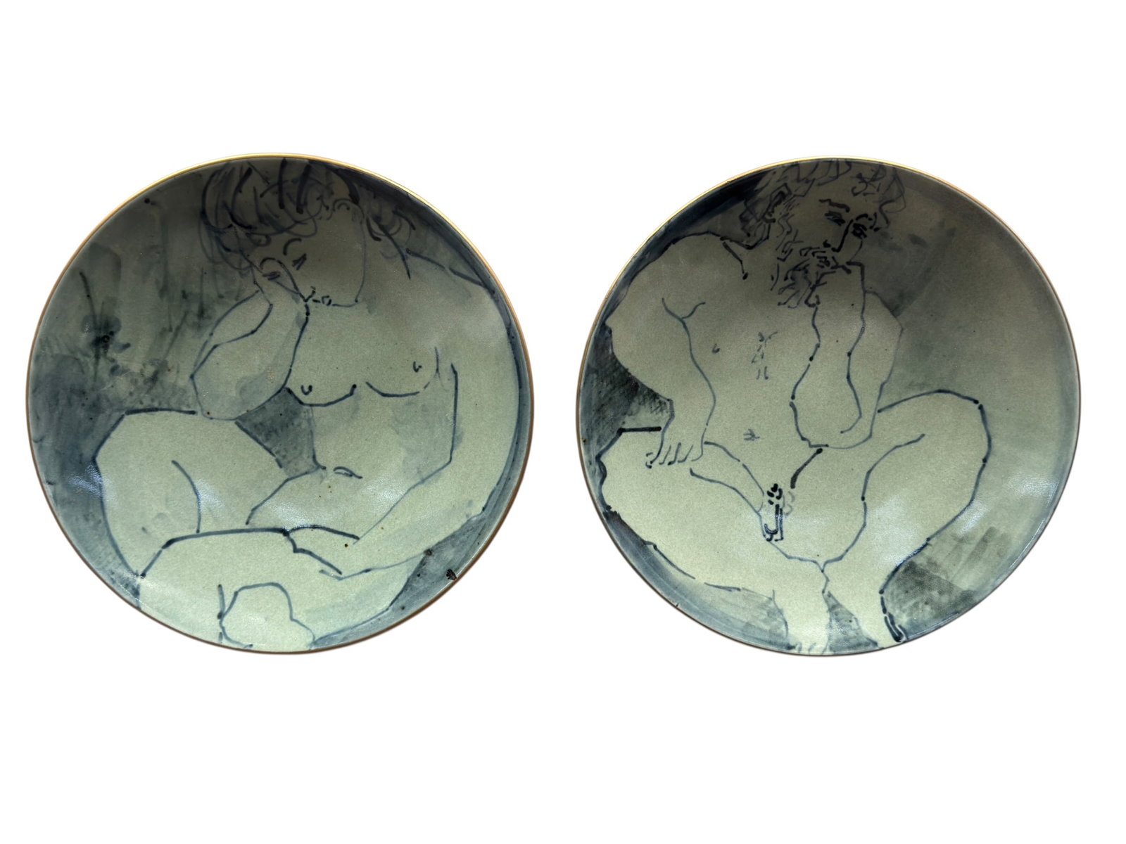 Pair of Ken Ferguson Style Studio Pottery Nude Figure Charger Plates: This pair of contemporary or mid-century style studio pottery charger plates features hand-painted underglaze illustrations of reclining female nude figures. In style of Ken Ferguson. The artwork is r