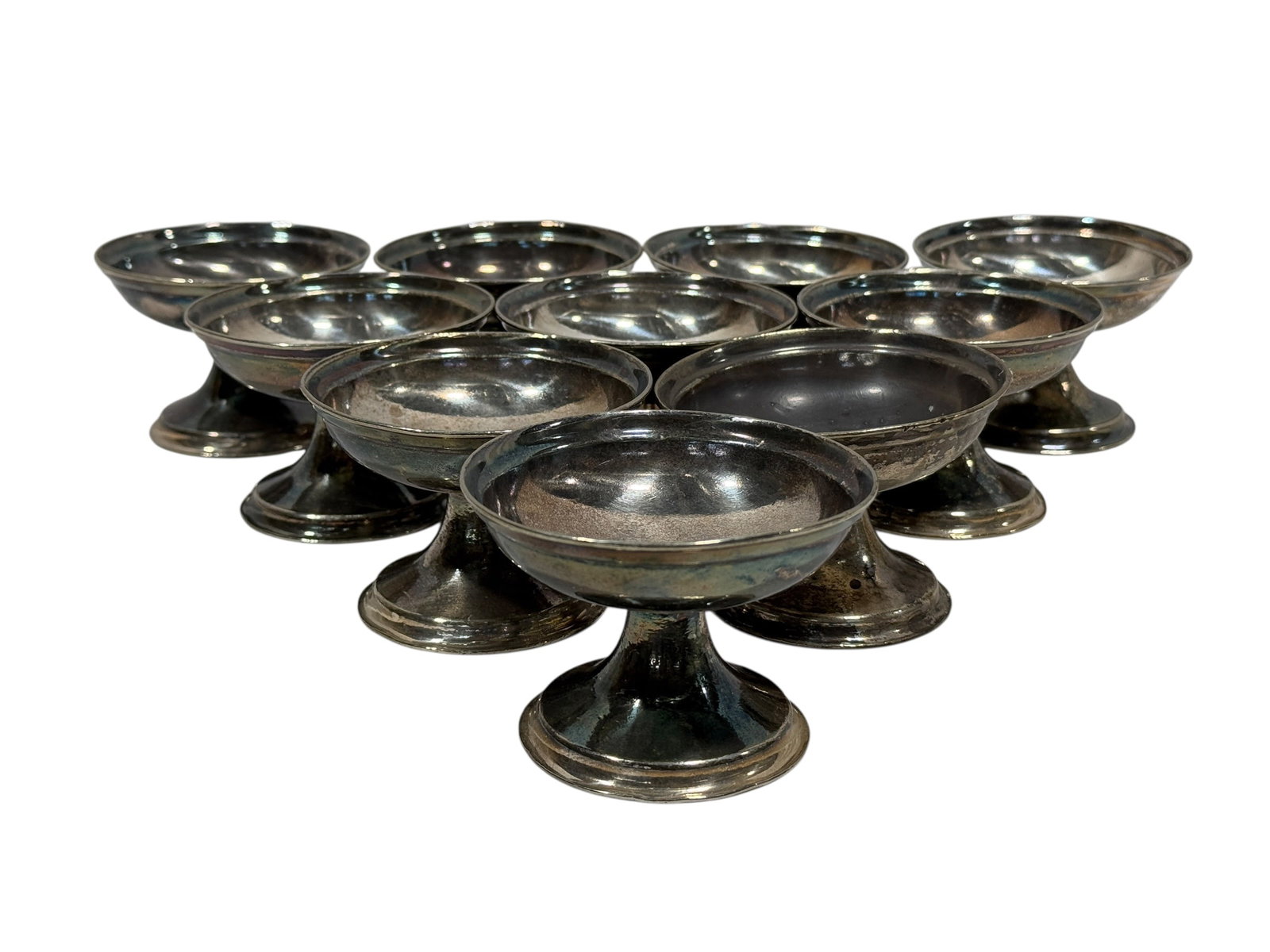 (10) Antique Hotel Silver Soldered Footed Sherbet Dessert Cups: This collection comprises ten antique silver-soldered footed sherbet cups, originally commissioned for the historic Chicago Athletic Association. Each piece is marked on the top side of the base with 