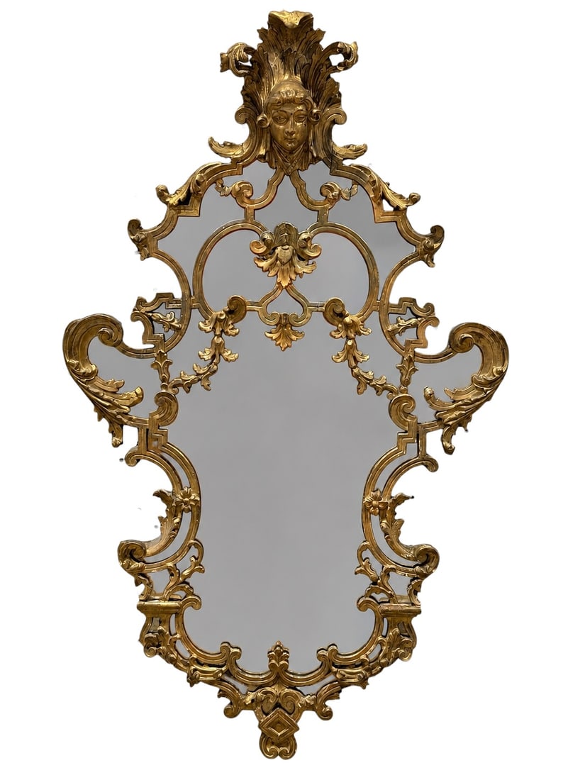 18th c. Ornate Italian Giltwood & Gesso Wall Mirror: This is an elaborate, heavily ornamented wall mirror, characteristic of 18th-century Italian craftsmanship. The frame is finished in a warm gold gilt and features a striking, central figural crest dep