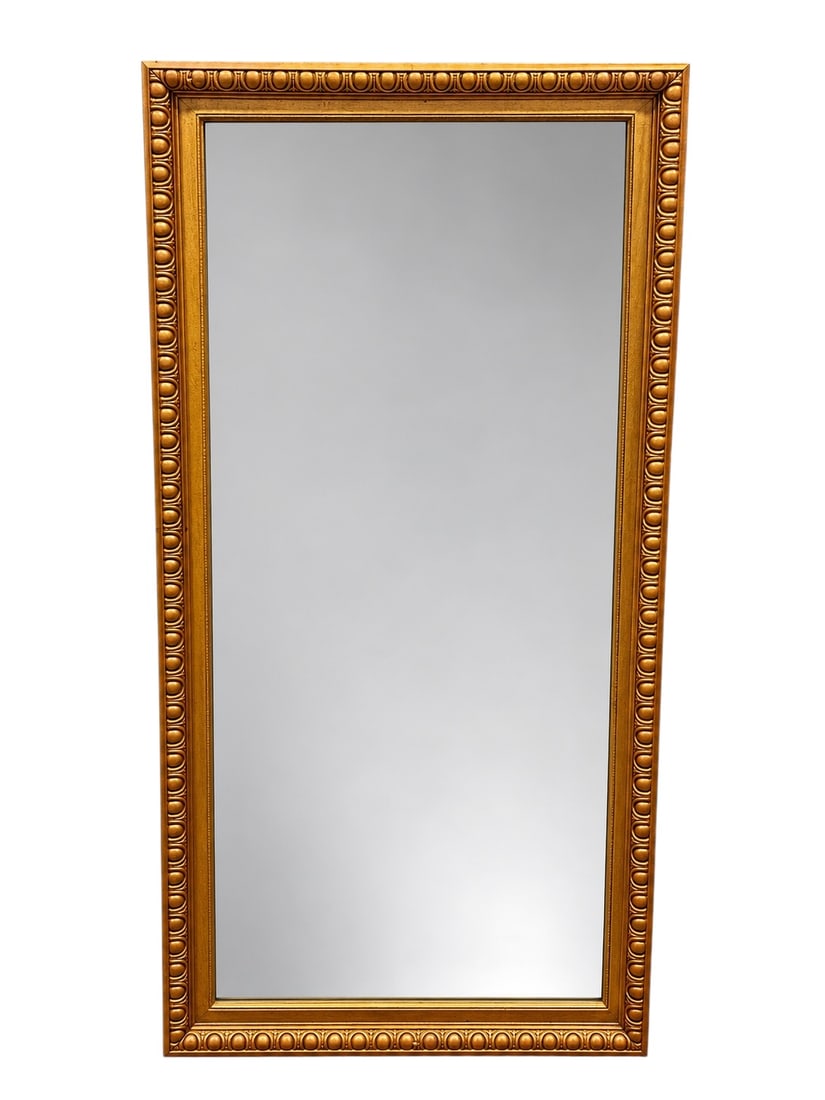 Antique Giltwood Mirror with Beveled Glass: This rectangular, wall-mounted mirror features a decorative frame with a classic repeating medallion or "coin" motif molding. The frame is constructed of wood layered with gesso and finished in a gold