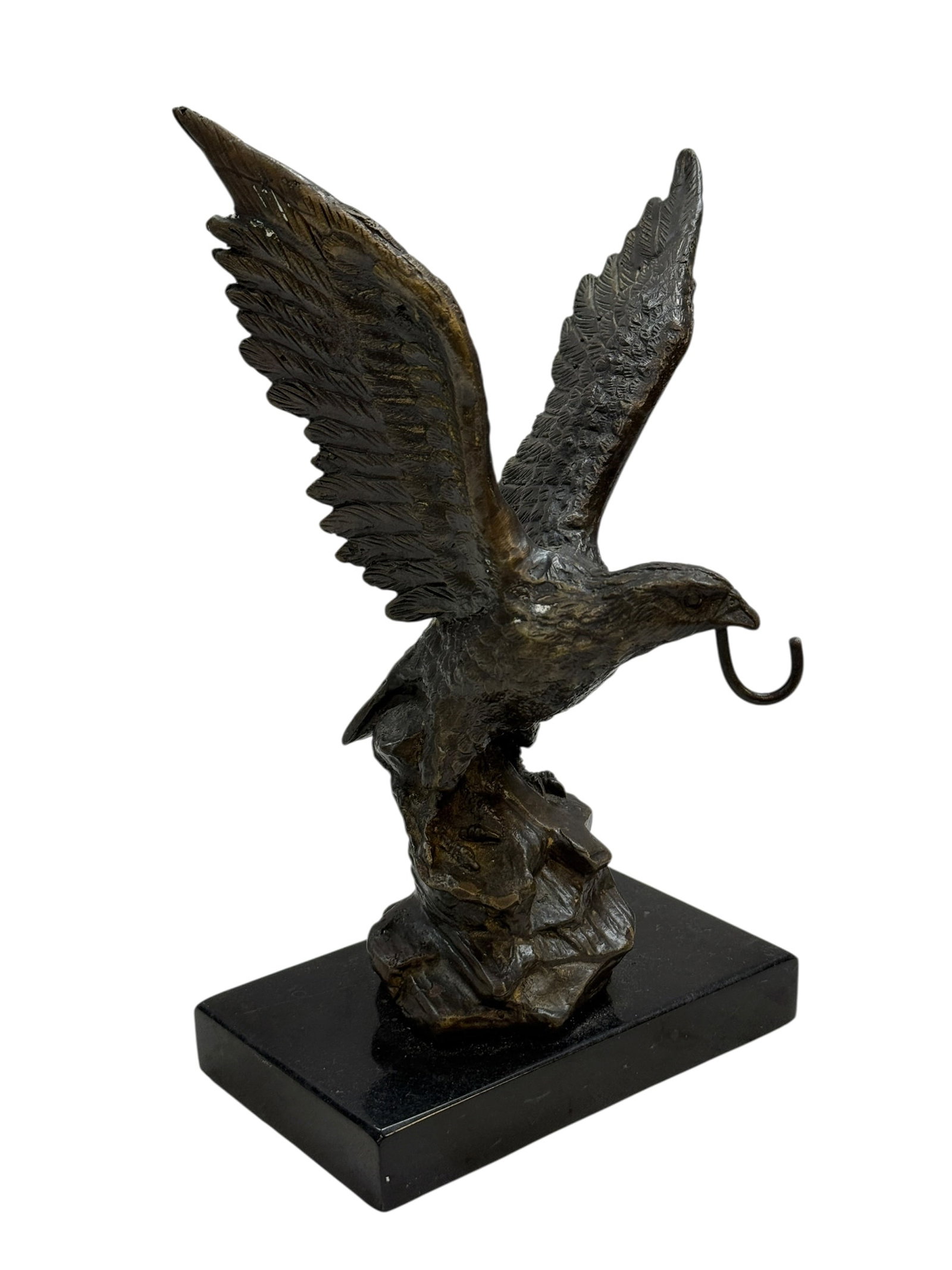 Cast Bronze Eagle Pocket Watch Holder: This decorative sculpture depicts a majestic eagle with wings spread, mounted upon a rugged base and set on a polished rectangular black plinth. The eagle features an unusual integrated bronze hook ex