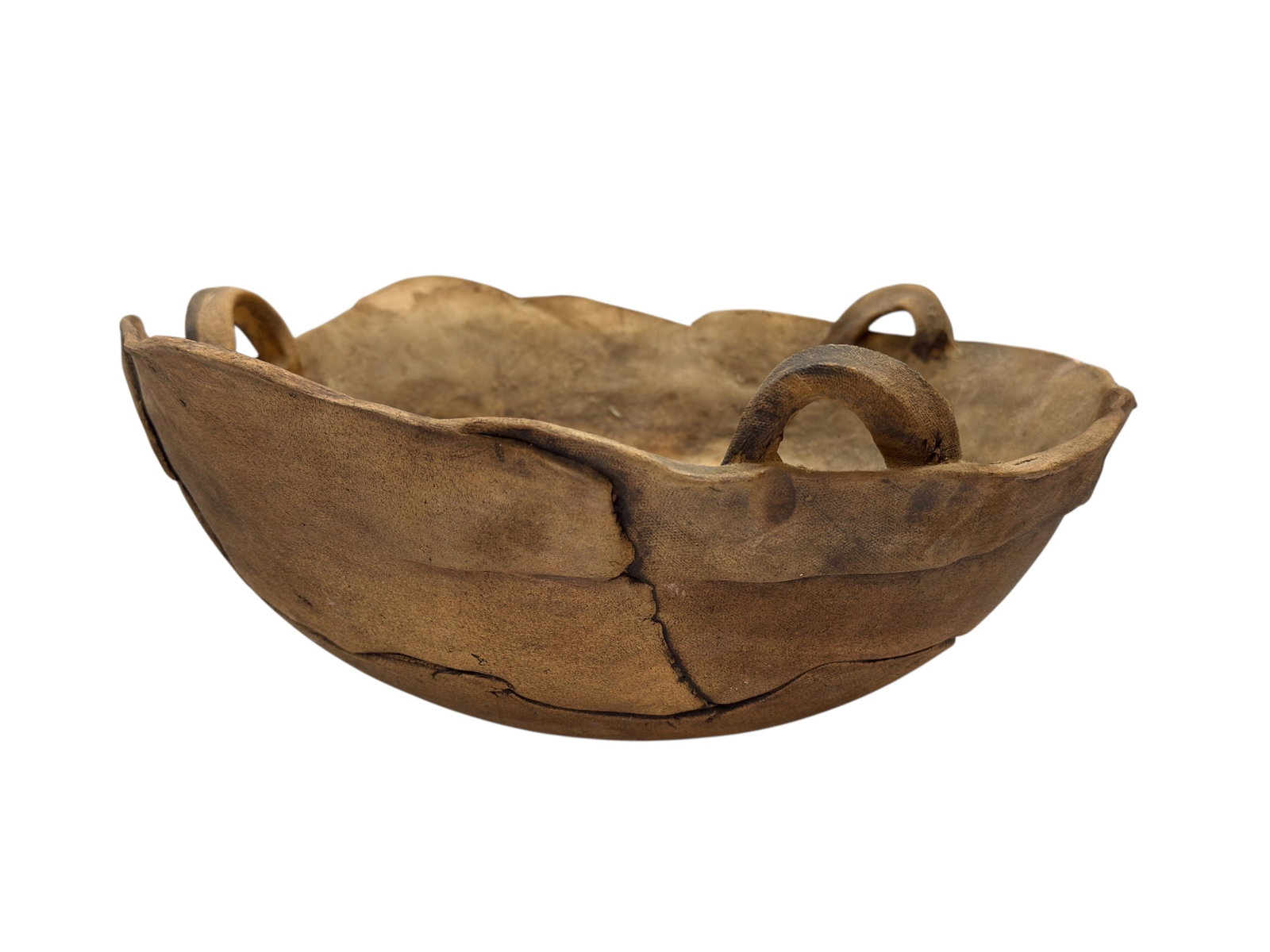 Primitive Hand-Formed Leather or Hide Dough Bowl with Handles: This primitive, hand-formed bowl features a rustic, organic construction, likely crafted from hardened leather or animal hide, finished with integrated handles. The bowl displays a deep, weathered pat