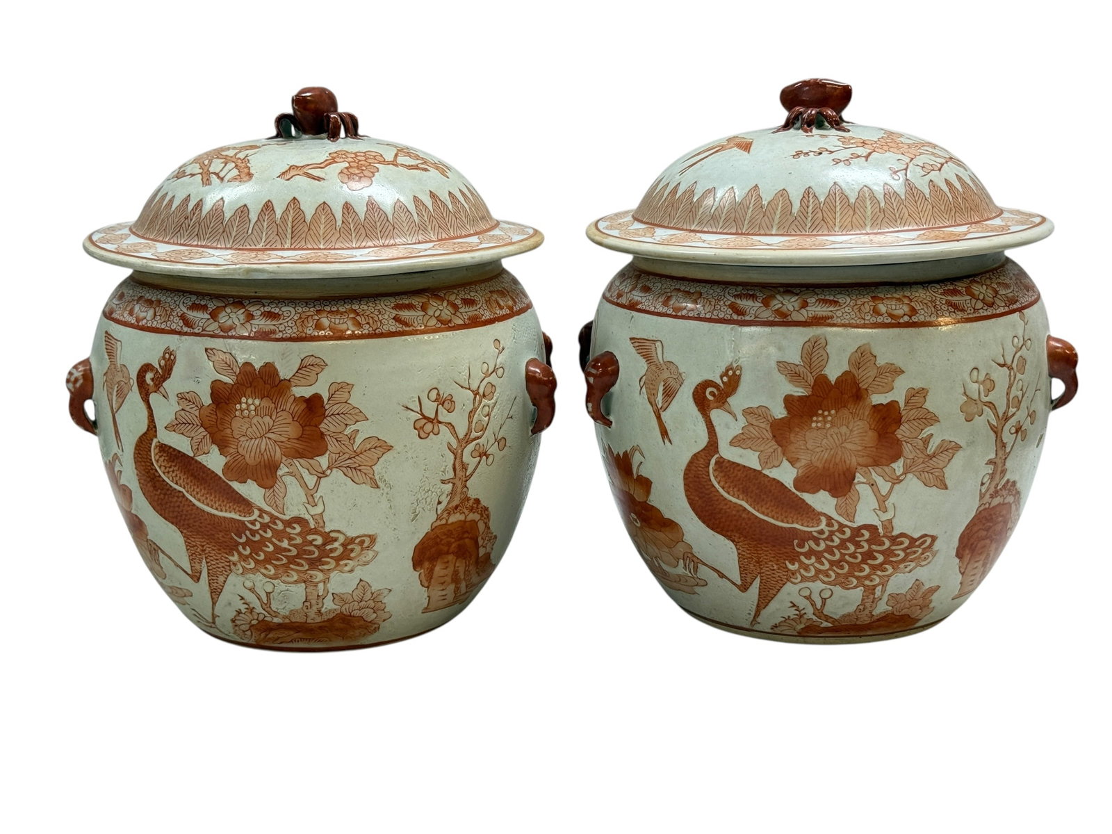 Pair of Orange and White Porcelain Ginger Jars: This pair of lidded porcelain ginger jars features intricate, hand-painted iron-red (often called fan-hong) designs against a white ground. The decorative motifs include naturalistic scenes with vario