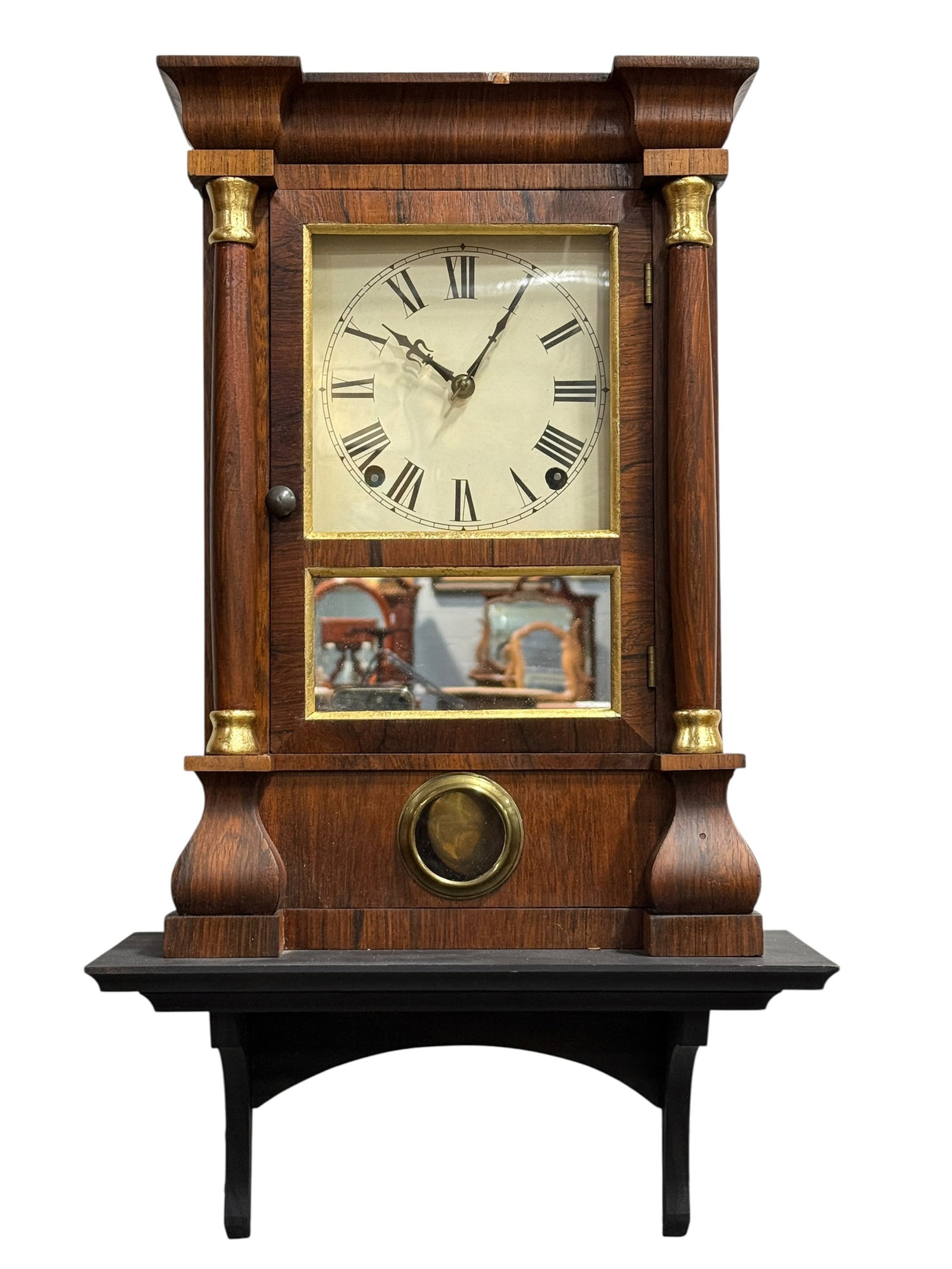 Antique Shipley "Patent Spring" Column Wall Clock: An antique architectural wall clock produced by Shipley, featuring their "Patent Spring" movement mechanism. The clock is housed in a rectangular wooden case with a prominent molded overhanging crown.