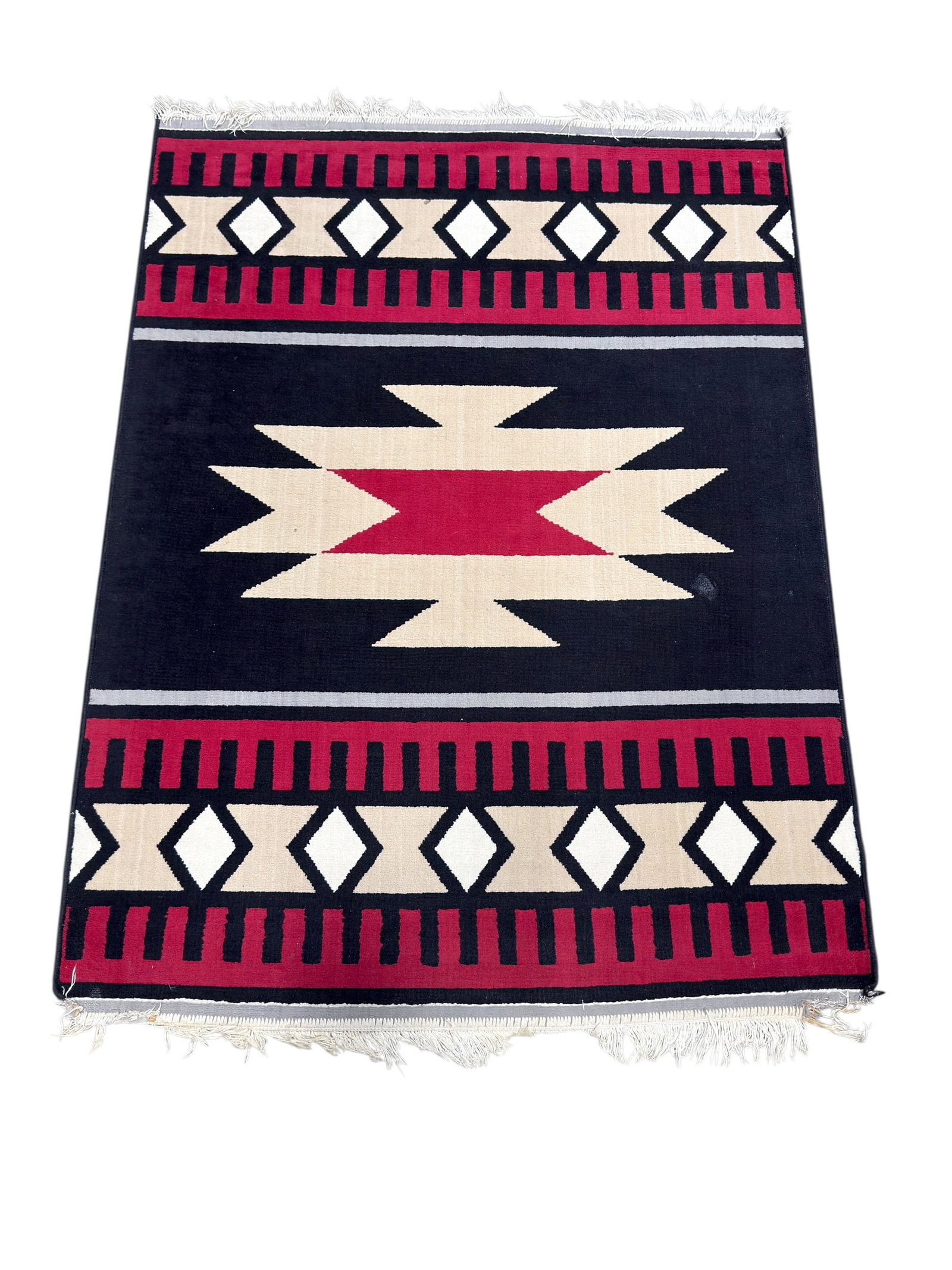 Southwestern Style Geometric Wool Area Rug: Southwestern or tribal-inspired geometric area rug featuring a bold central stepped diamond medallion in cream and red set against a black field, framed by repeating diamond and linear border motifs i