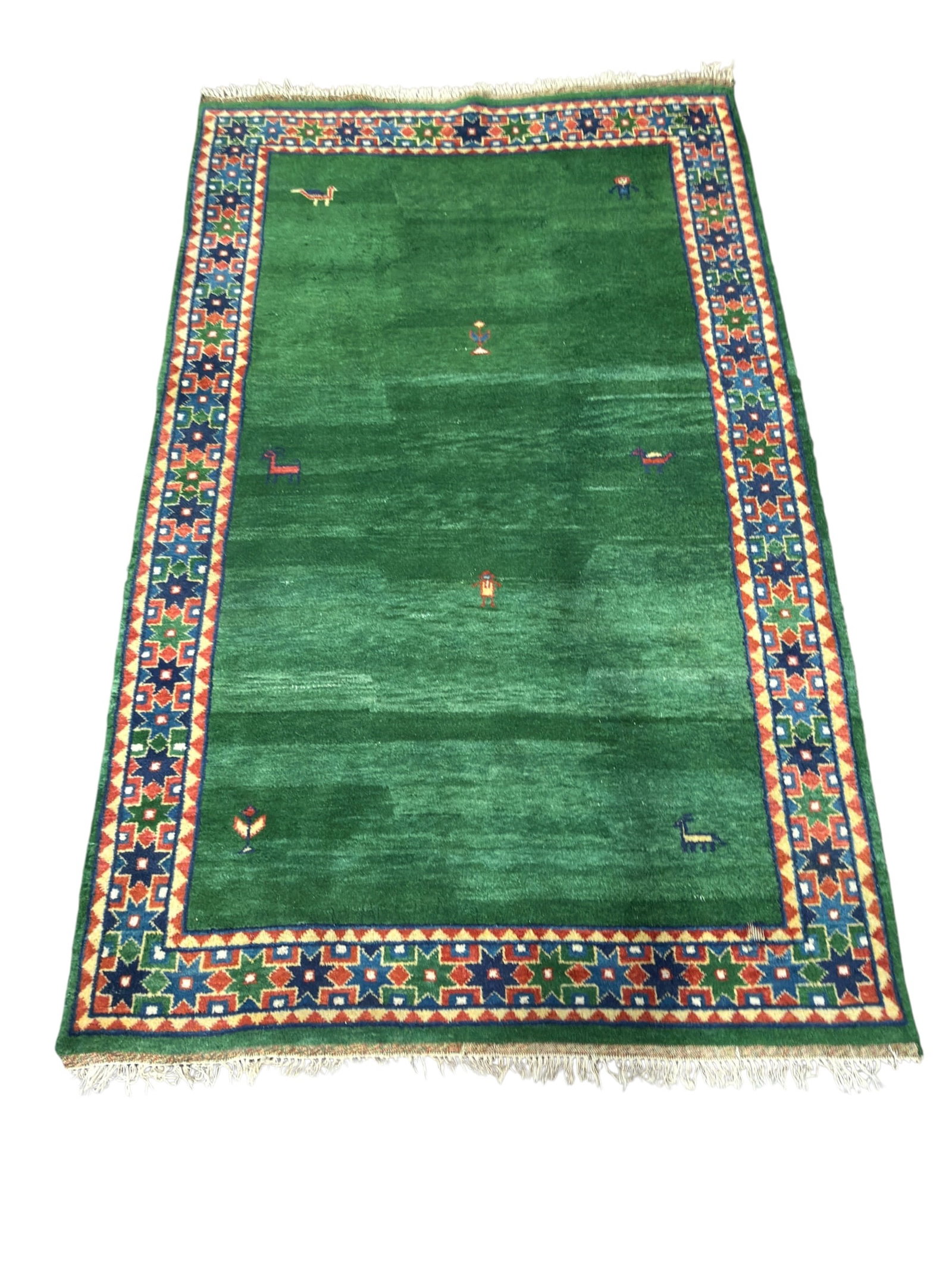 Persian Gabbeh Wool Area Rug: A contemporary Persian Gabbeh hand-knotted wool area rug. The composition features a vibrant, variegated emerald green field minimally decorated with small, charmingly primitive tribal motifs scattere