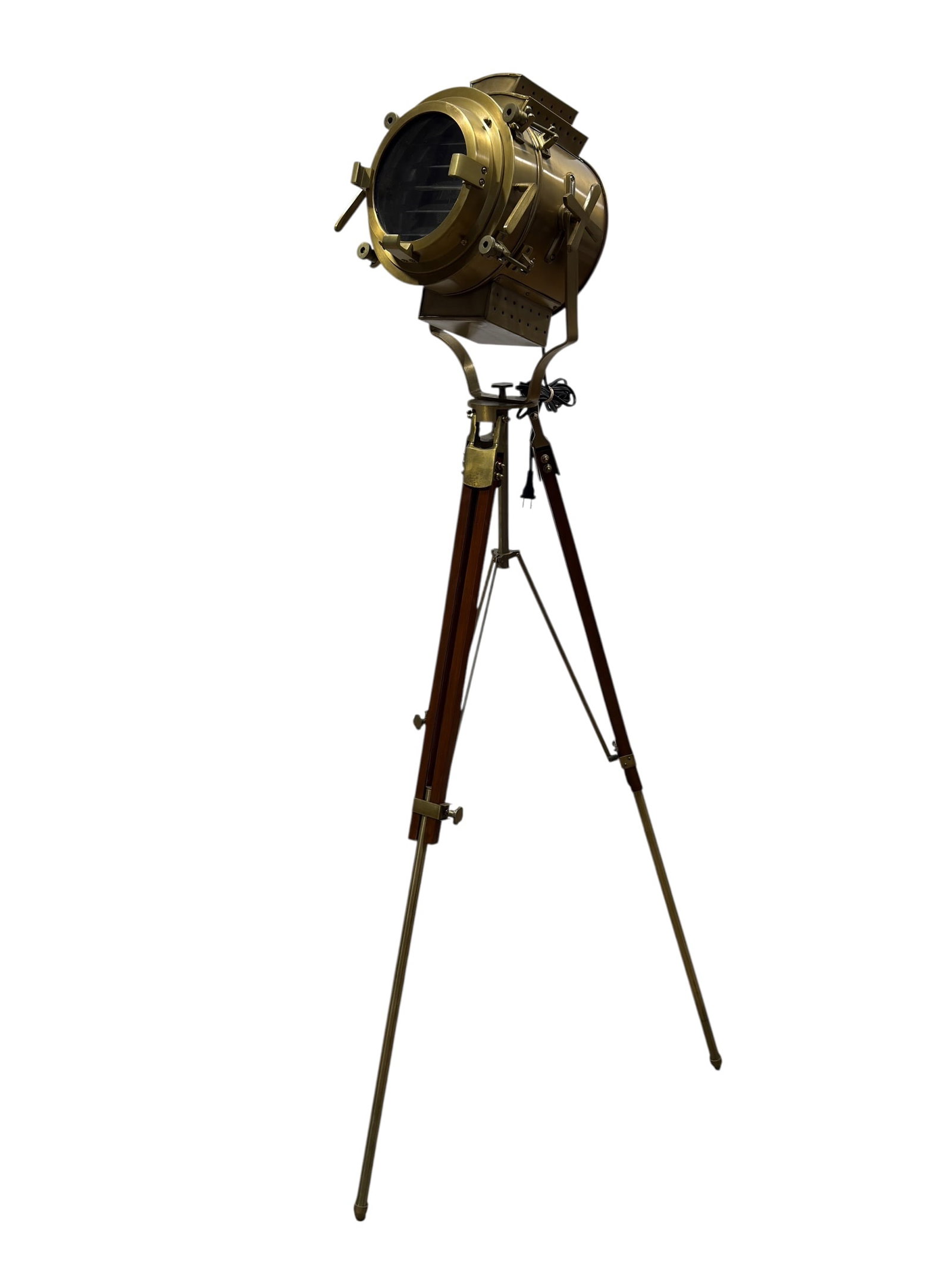 Brass Marine Style Searchlight on Adjustable Tripod Stand: substantial maritime-themed spotlight featuring a heavy cylindrical brass housing with a hinged front bezel secured by robust swing-bolt latches. The face of the lamp is fitted with segmented glass lo