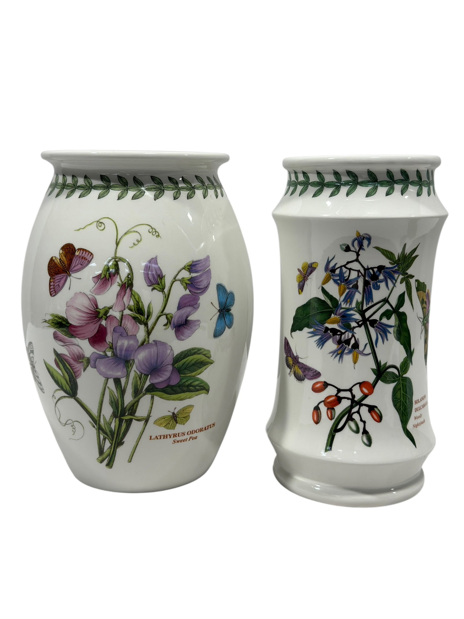 Pair of Portmeirion "The Botanic Garden" Ceramic Vases: A pair of glazed ceramic vases in two distinct silhouettes from Portmeirion’s iconic "The Botanic Garden" collection. The lot includes a slightly waisted cylindrical vase featuring the vibrant "Sola