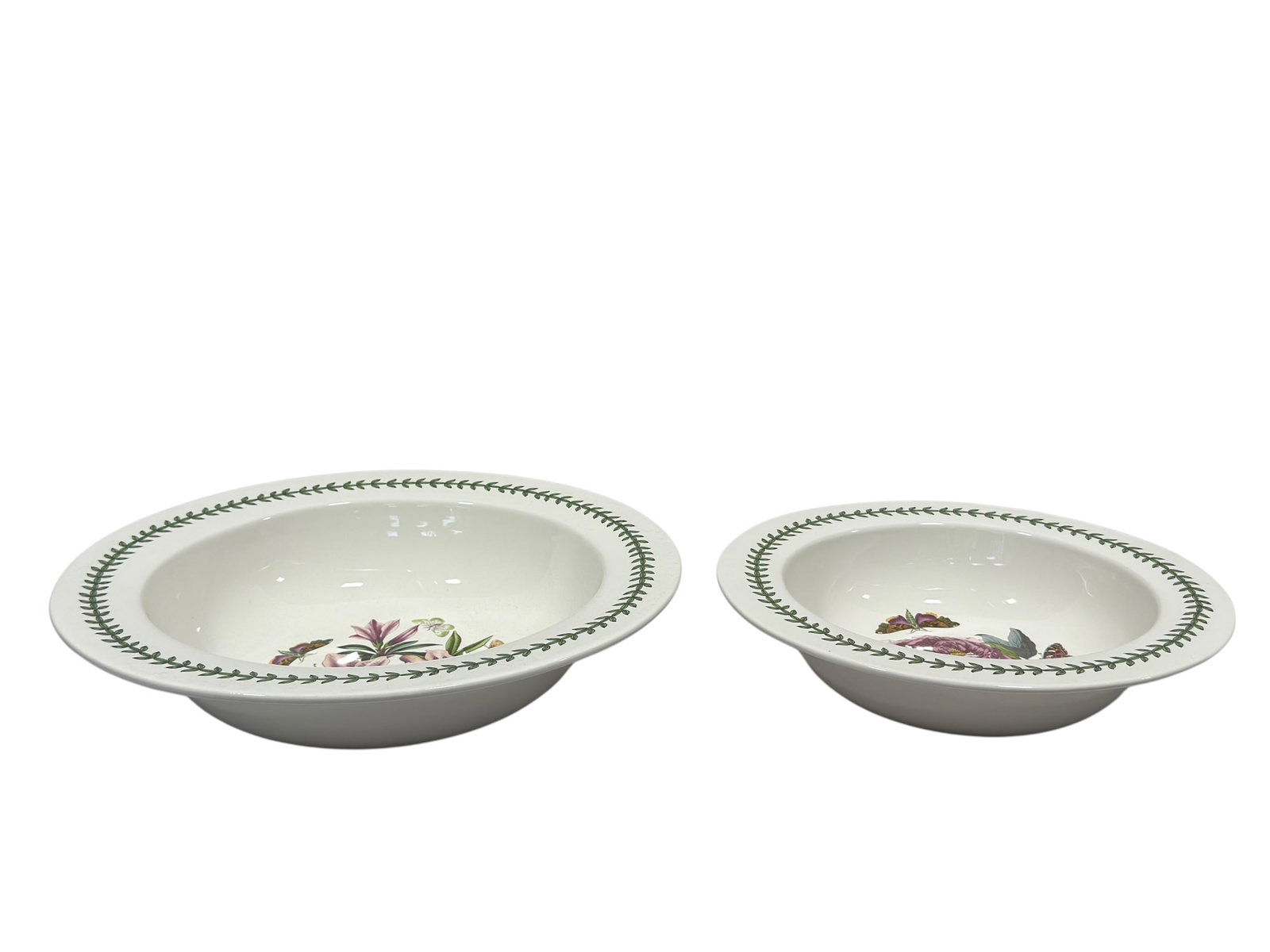 Pair of Portmeirion "The Botanic Garden" Ceramic Serving Bowls: A pair of circular ceramic serving bowls by Portmeirion from "The Botanic Garden" collection. The lot comprises a bowl featuring "Paeonia Moutan / Shrubby Peony" alongside a slightly larger bowl displ