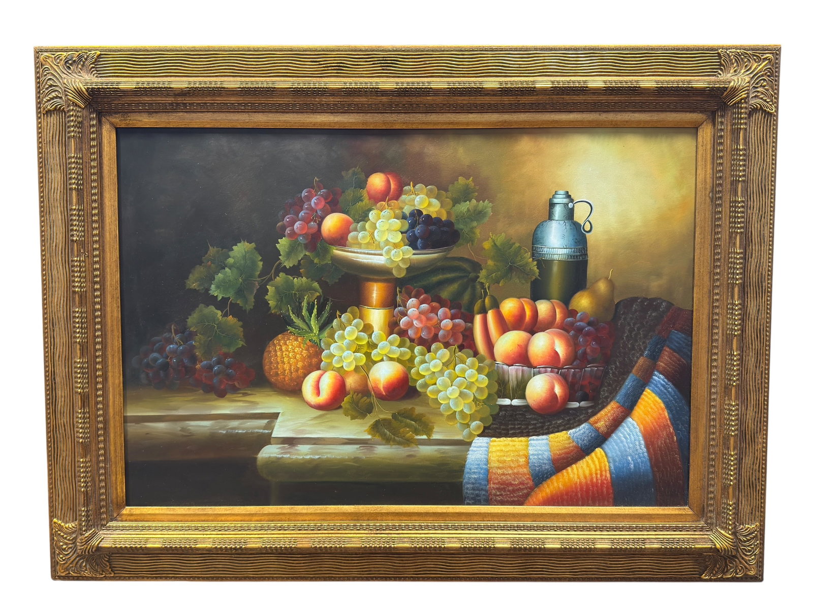 20th C. Traditional Still Life Oil Painting on Canvas: Finely executed oil on canvas still life depicting an abundant tabletop arrangement of fruit, including cascading clusters of red, white, and purple grapes, peaches, pears, bananas, and a pineapple su