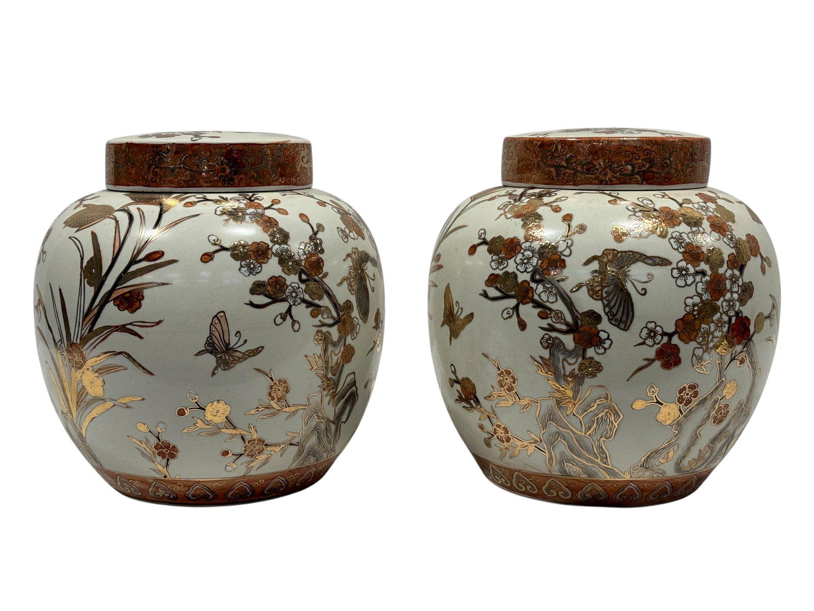20th C. Asian Gilt and Enameled Porcelain Ginger Jars, Pair: A decorative pair of covered porcelain ginger jars, each with a rounded baluster-form body and fitted circular lid. The pale celadon-toned grounds are richly embellished with flowering branches, butte