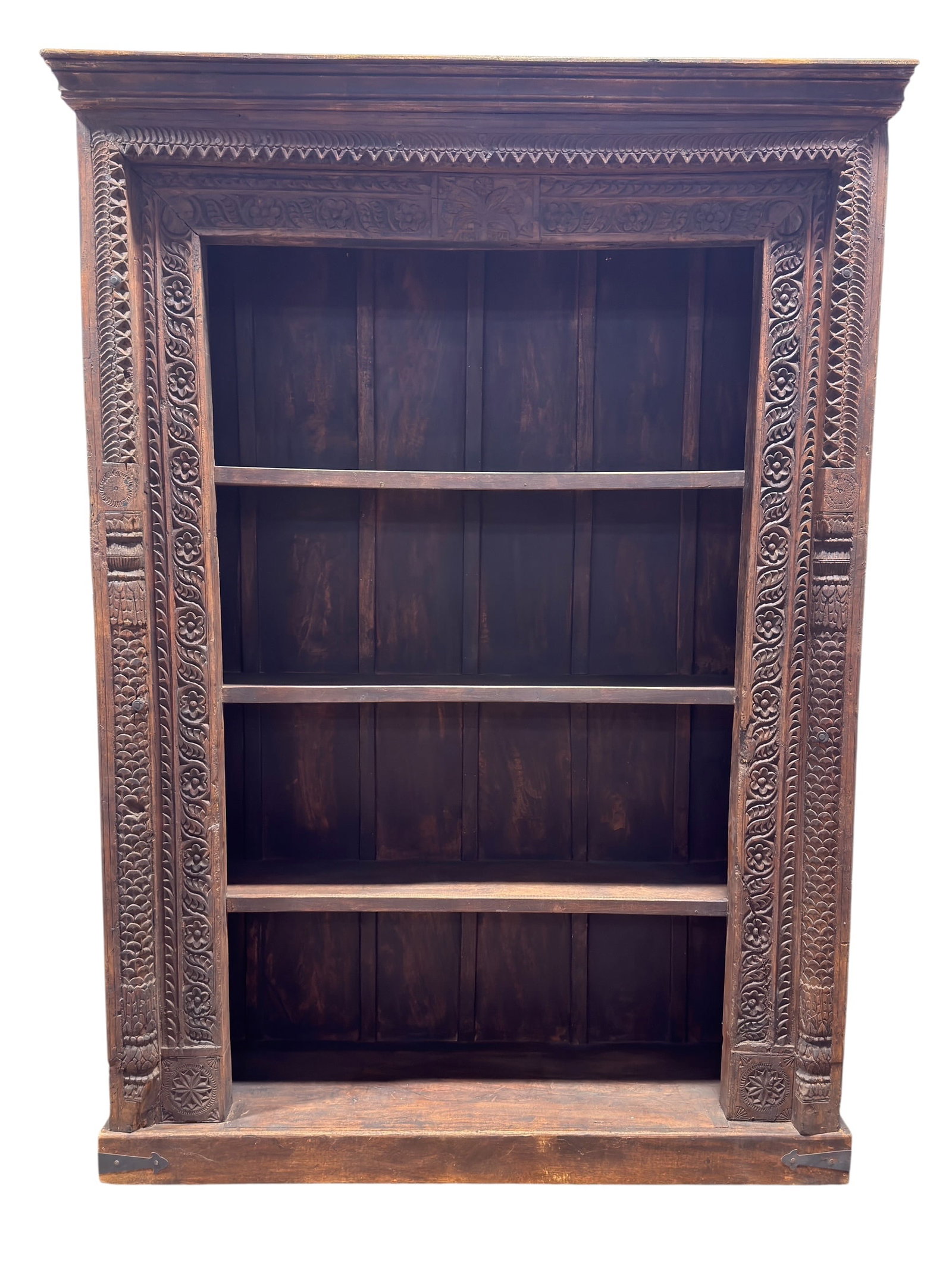 Late 19th-Early 20th C. Indian Carved Hardwood Open Bookcase: A substantial Indian carved hardwood open bookcase of architectural form, featuring three broad fixed shelves within an elaborately carved surround. The upright stiles are densely worked with repeatin