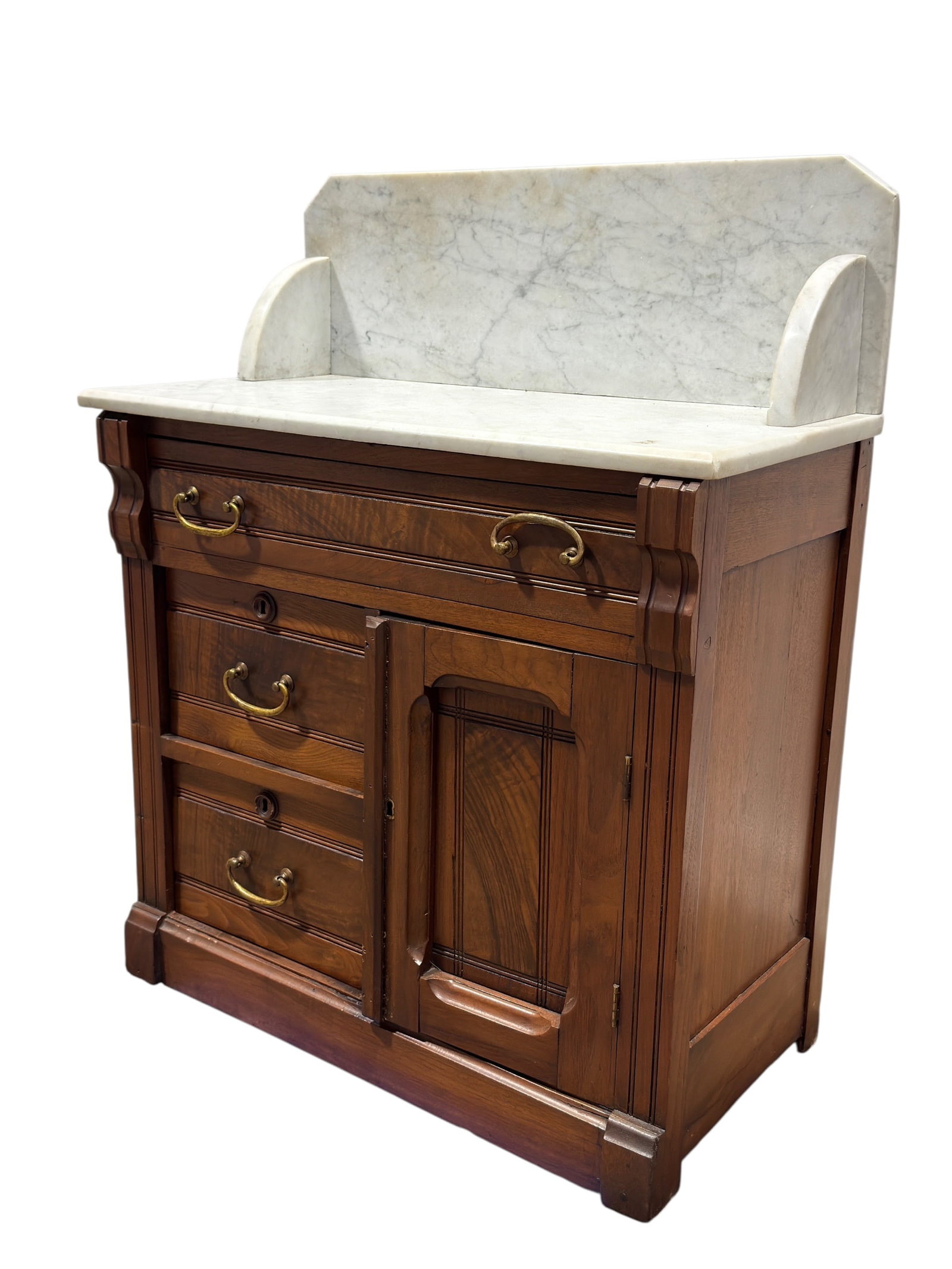 Antique Victorian Marble Top Walnut Washstand: Antique Victorian walnut washstand or commode cabinet featuring a white marble top fitted with a tall veined marble backsplash and curved side supports. The warm walnut case is enriched with figured d
