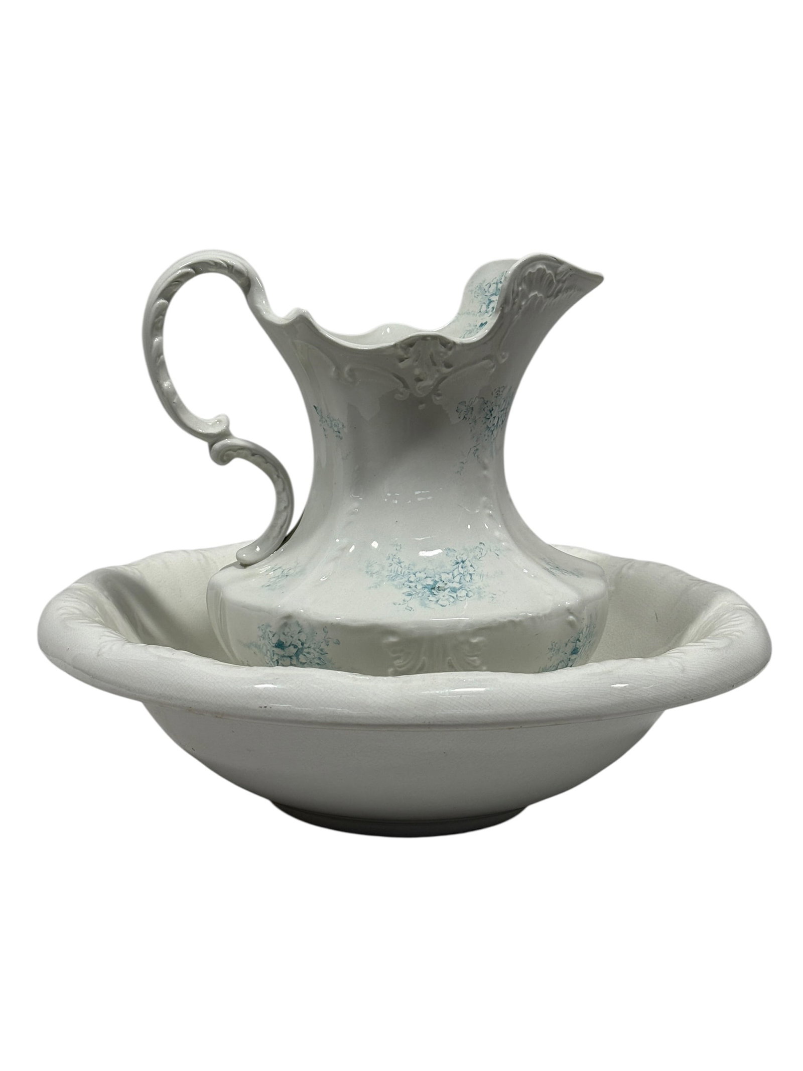 Antique Victorian Porcelain Pitcher and Wash Basin Set: Antique Victorian two-piece porcelain wash set comprising a tall ewer-form pitcher and coordinating circular basin, each finished in glossy white and decorated with delicate pale blue floral sprays. T