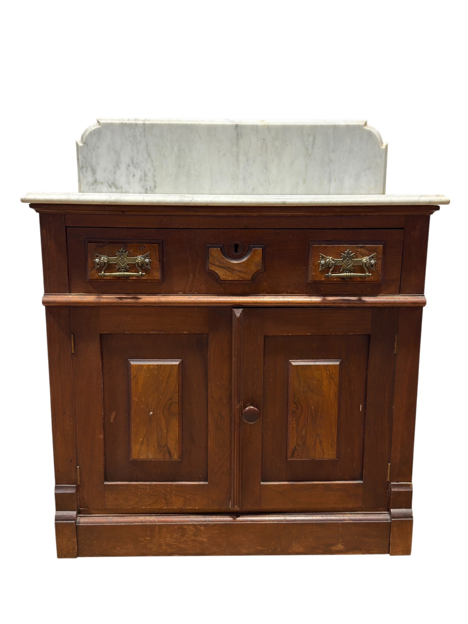 Antique Victorian Eastlake Marble Top Washstand: This handsome late 19th to early 20th century marble-top washstand features its original white marble top and raised backsplash, combining practical utility with timeless Victorian design. Crafted in 