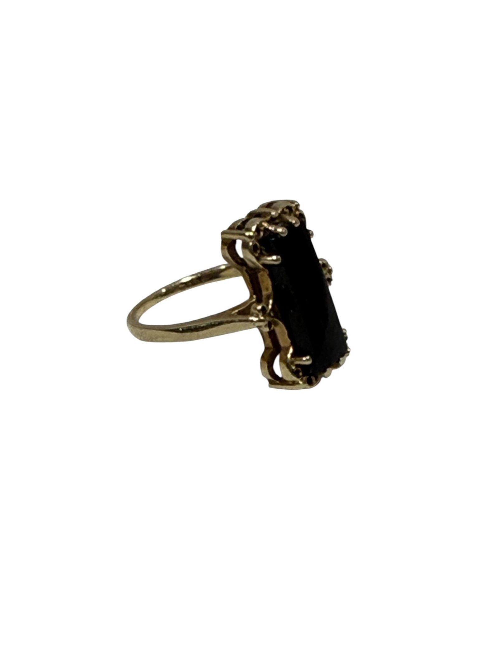 Vintage 10K Gold Black Onyx Cocktail Ring: Vintage 10K yellow gold cocktail ring centered by a long rectangular polished black stone, likely onyx, held within an ornate openwork setting with decorative scroll and bead-like detailing framing th