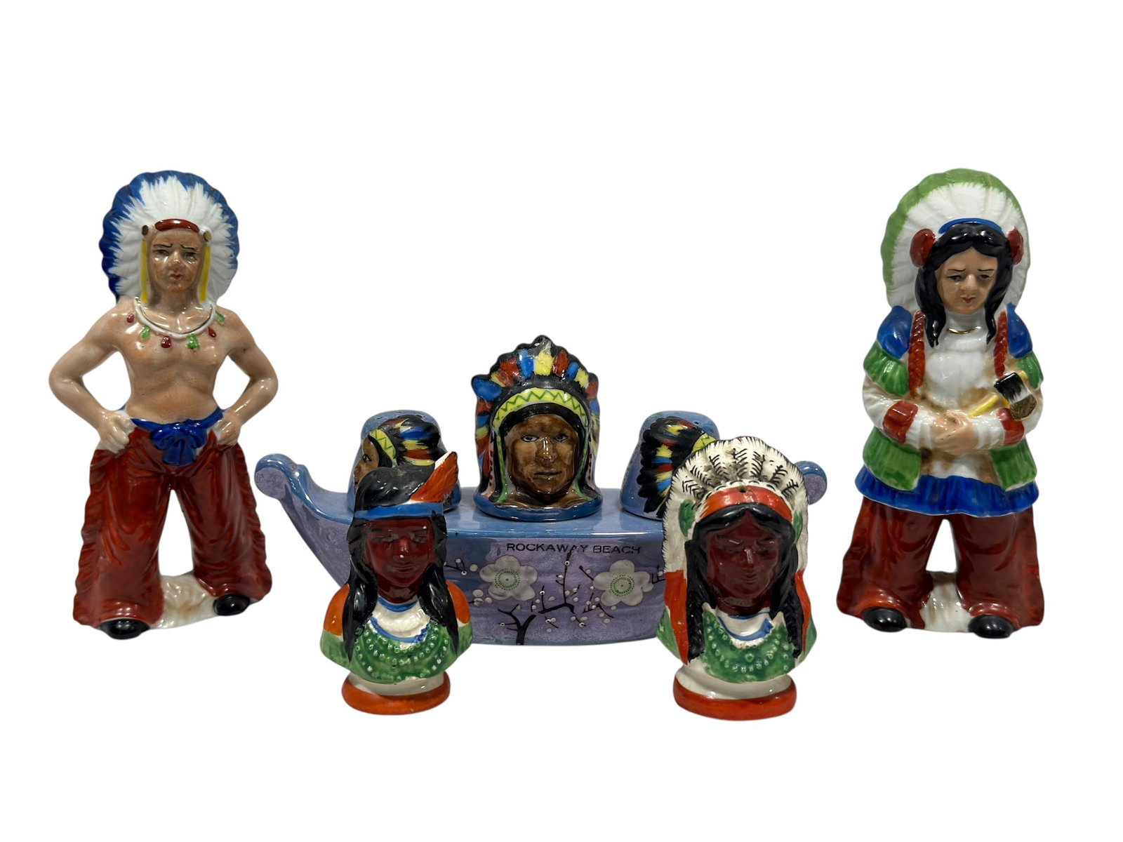 Vintage Native American Figural Salt & Pepper Shaker Group w/ Figures: Vintage Japanese ceramic novelty condiment group featuring a colorful collection of Native American-themed figural salt and pepper shakers together with a distinctive pale blue canoe-form holder. The 