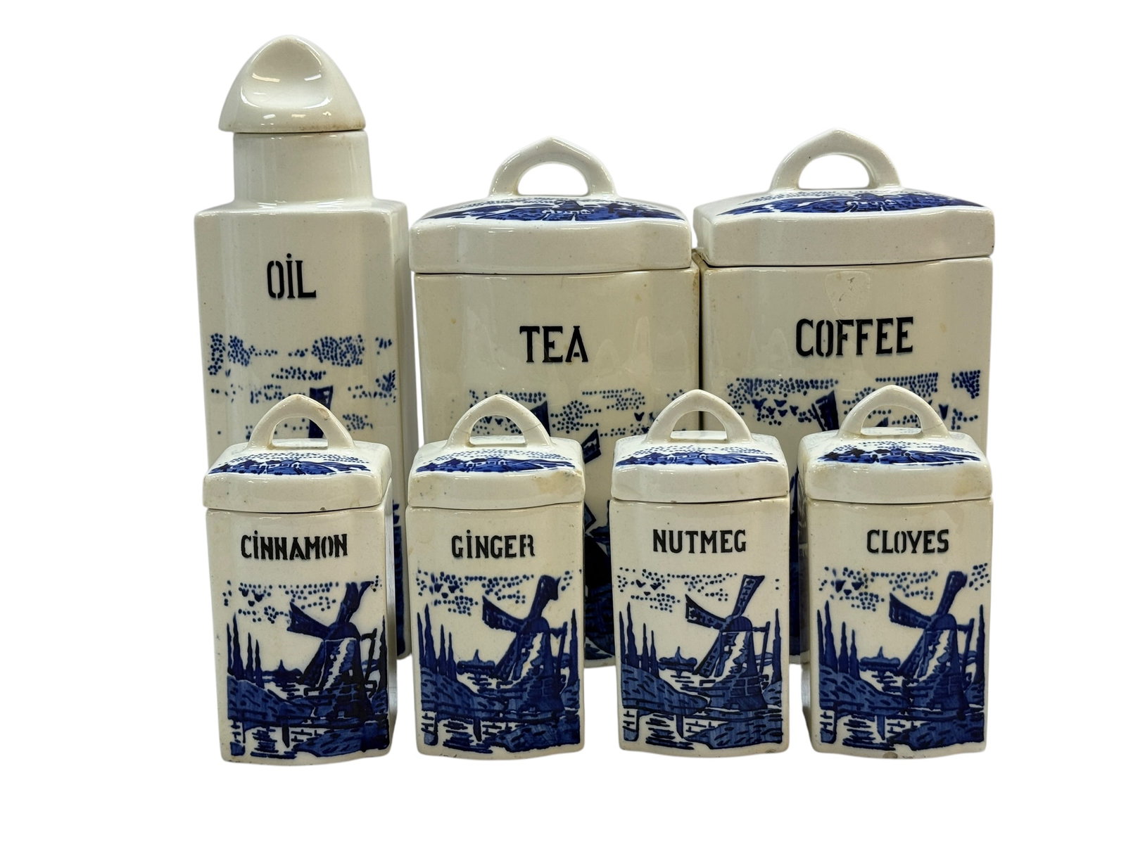 7 Pc. Vintage Max Roesler German Blue & White Windmill Ceramic Canister & Spice Set: A charming, early 20th-century German fine earthenware (Feinsteingut) kitchen canister and spice lot manufactured by Max Roesler in Rodach, Bavaria. The set features a classic blue-and-white Delft-sty