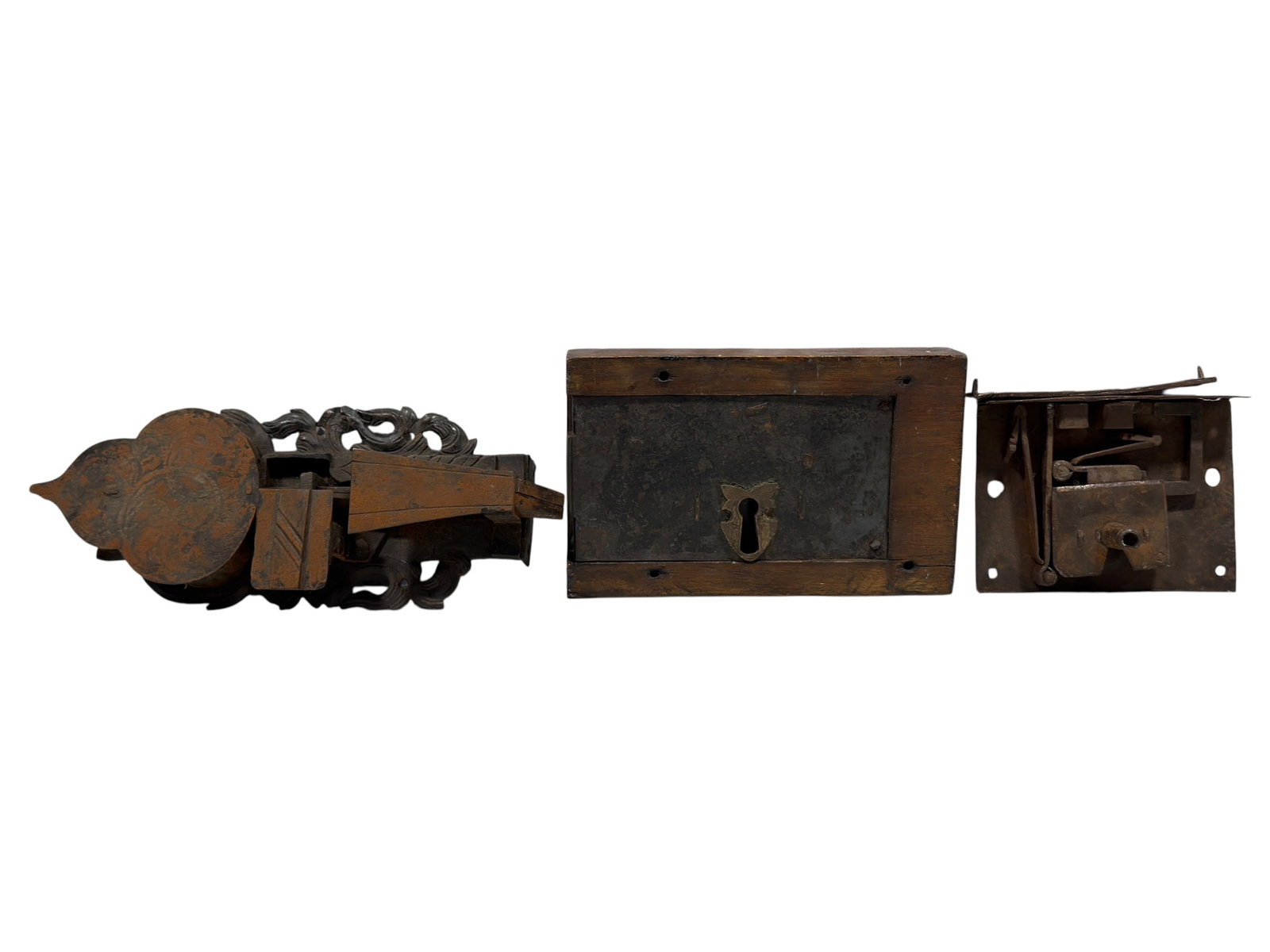 (3) 18th-19th Century Style Antique Architectural Locks: Group of three antique architectural locking mechanisms comprising a rectangular wood-mounted box lock with centered keyhole and metal escutcheon, an elaborately shaped iron rim or surface lock with p