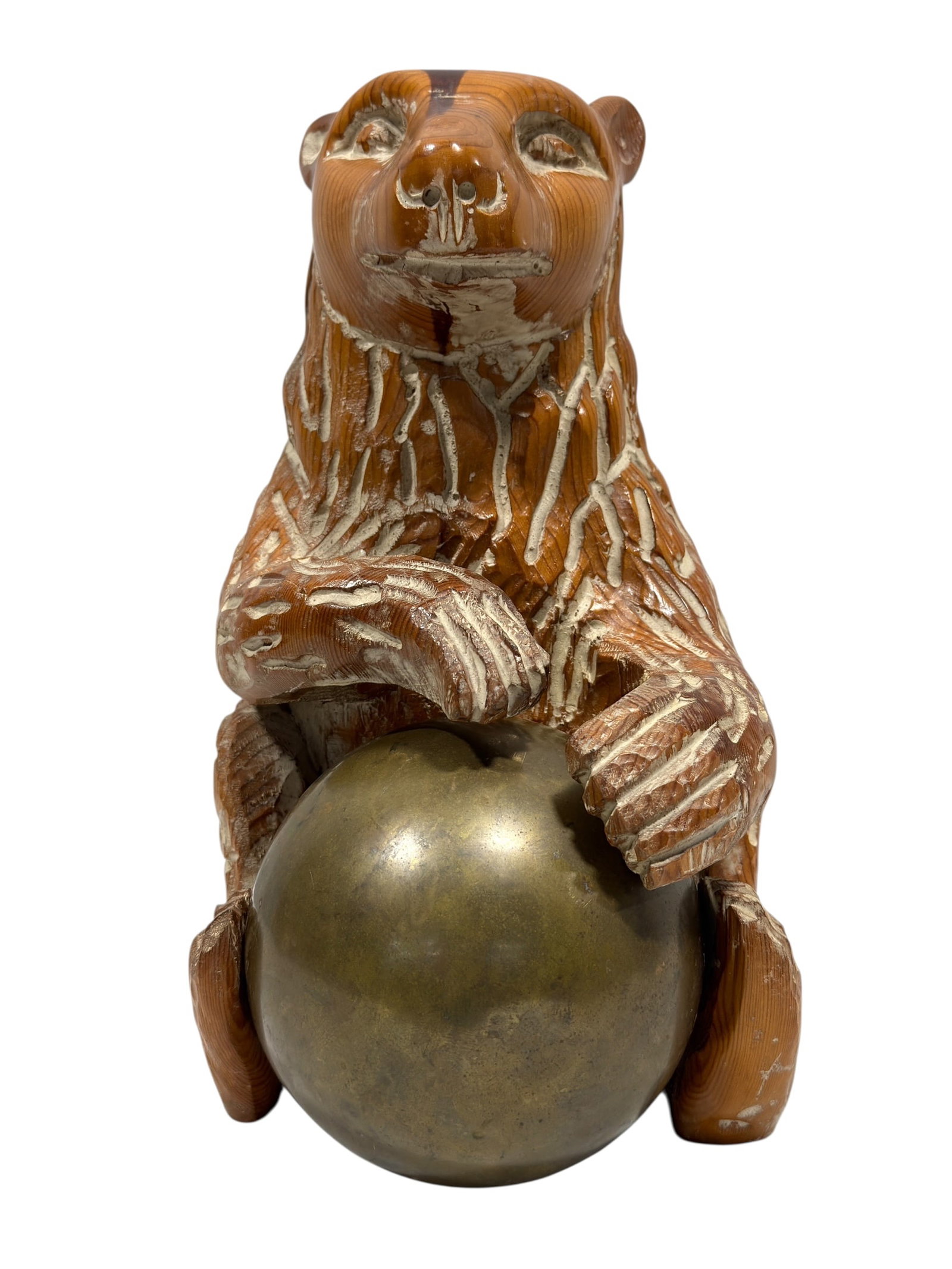 Sarreid Ltd. Mid-Century Carved Pine Bear with Brass Ball Sculpture: A wonderfully expressive mid-century decorative sculpture attributed to Sarreid Ltd., circa 1970s, featuring a hand-carved pine bear seated upright and clutching a large spherical brass ball between i