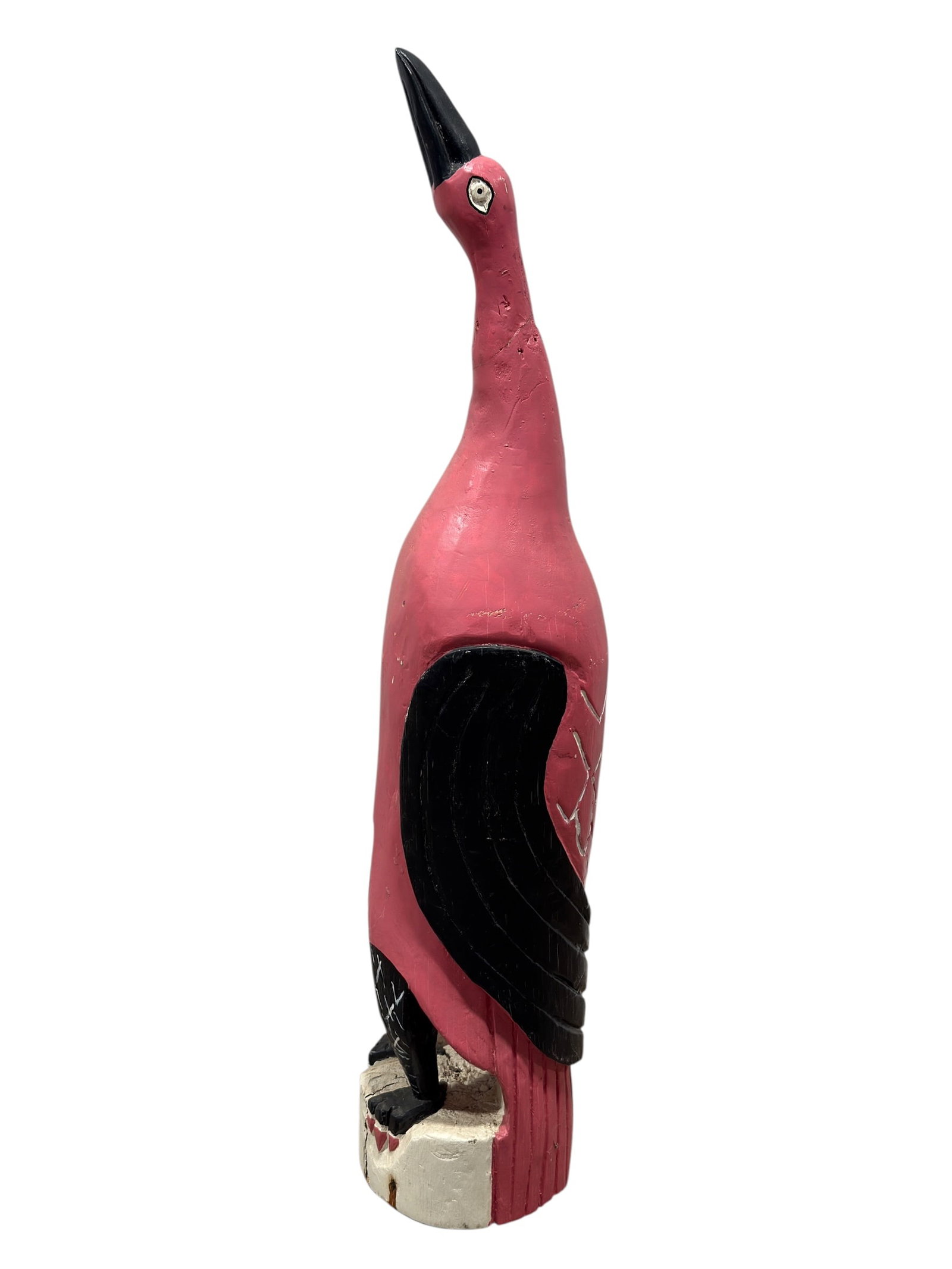 Large Painted Carved Wood Flamingo Folk Art Sculpture: A large hand-carved and painted wood flamingo sculpture with a tall, elongated profile, boldly rendered in vivid pink with black-painted beak and wing panels, white eye accents, and incised feather de