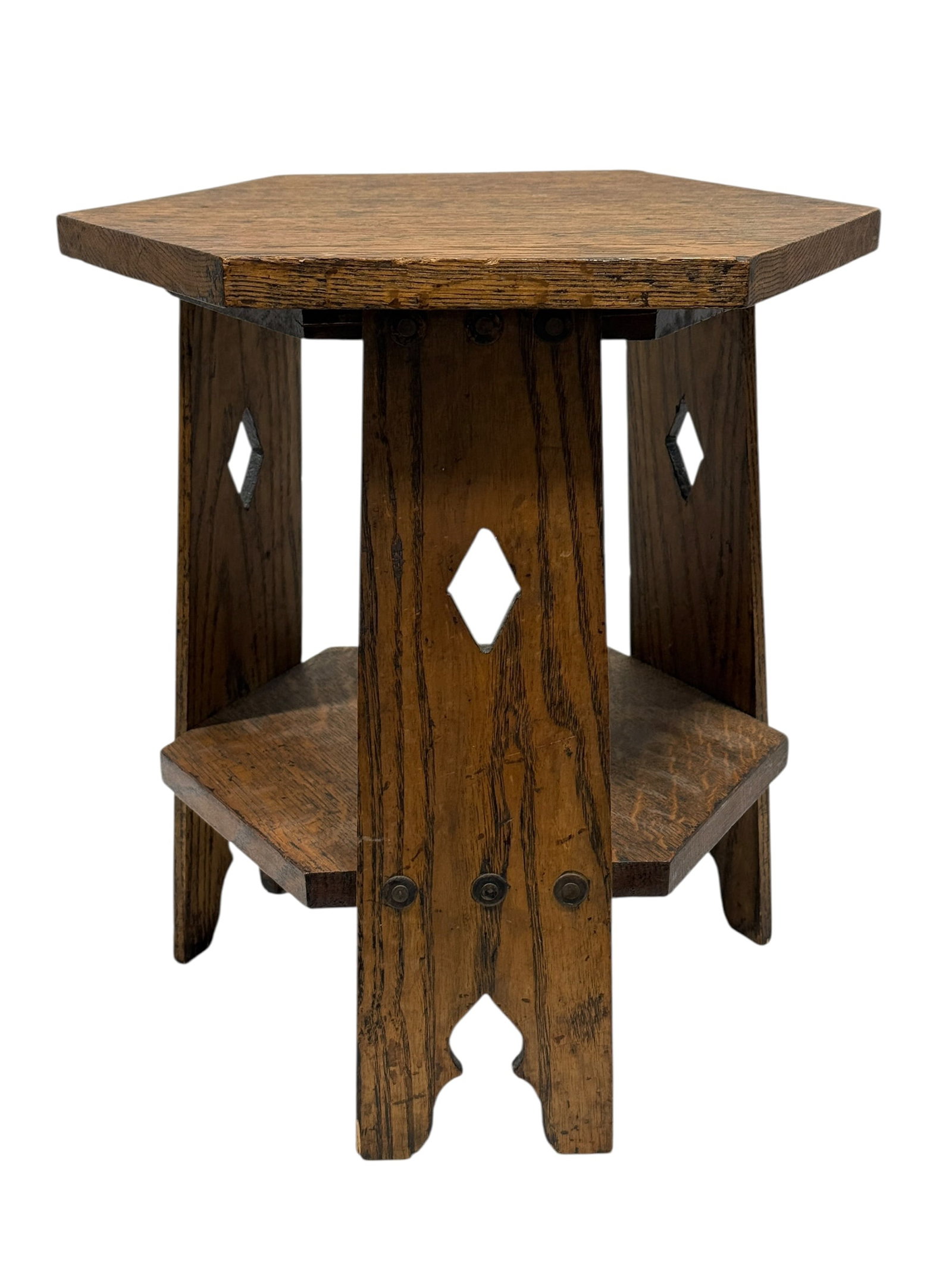 Antique Arts & Crafts Oak 2 Tier Side Table: An antique Arts & Crafts / Mission-style oak side table, likely dating to the early 20th century, featuring a substantial chamfered polygonal top above sturdy slab-form supports with pierced diamond-s