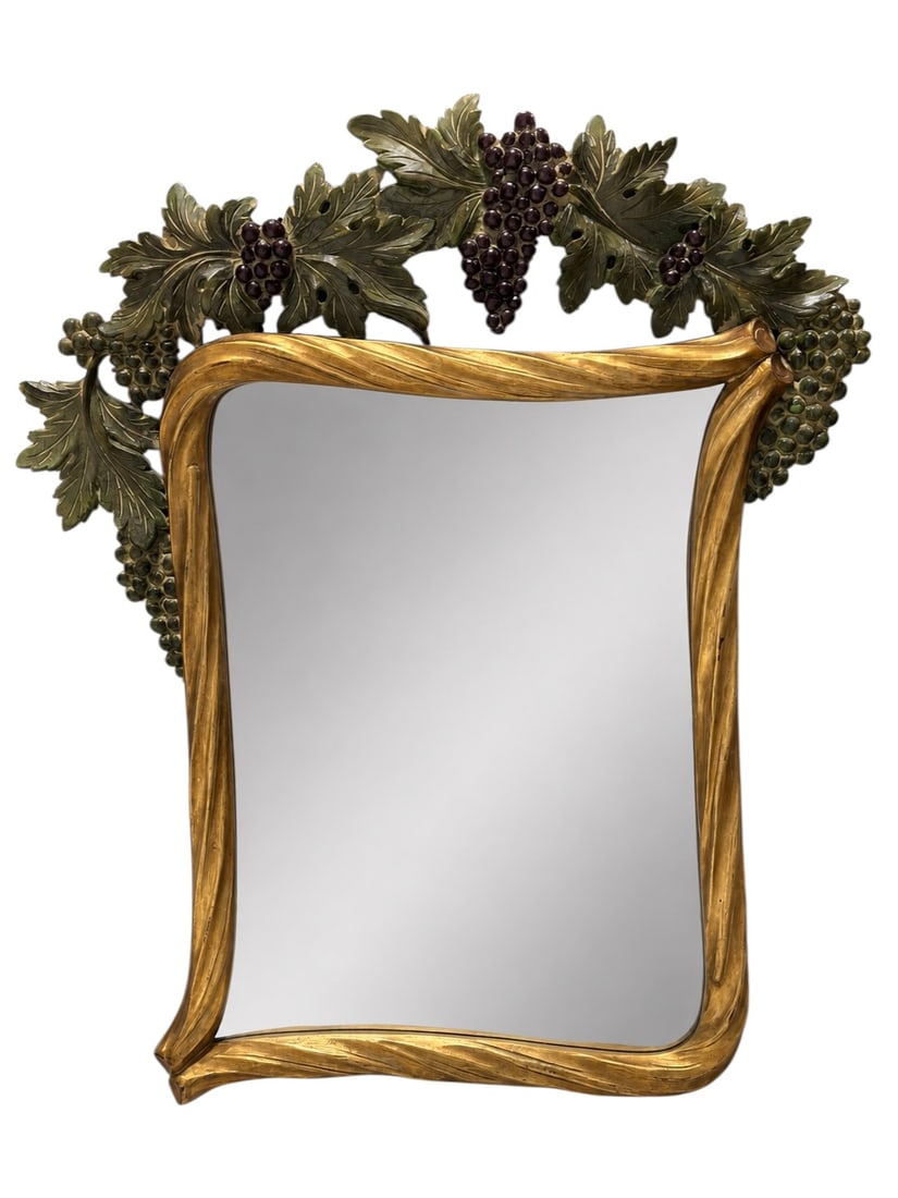 Large Decorative Grape Vine Wall Mirror w/ Sculptural Leaf and Fruit Crest: Large statement wall mirror designed with an exuberant sculptural grapevine surround, the rectangular mirror plate enclosed by a flowing, asymmetrical gold-toned frame whose sinuous contours evoke twi