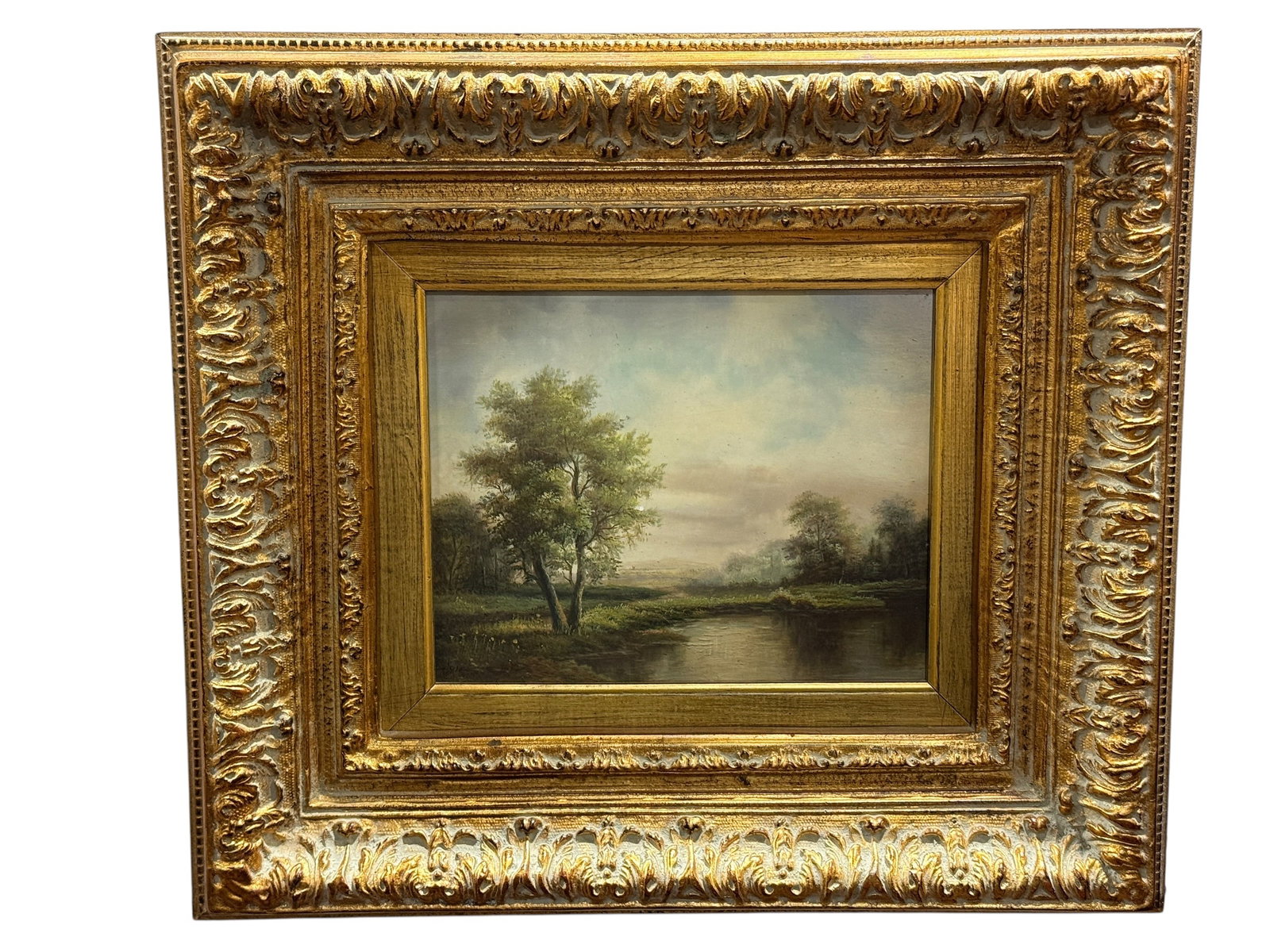 Hanz, Pastoral River Landscape, Oil on Board: Early-to-mid 20th century oil on board pastoral landscape, signed Hanz at the lower left, depicting a quiet river or pond winding through a broad wooded countryside beneath a softly luminous, clouded 