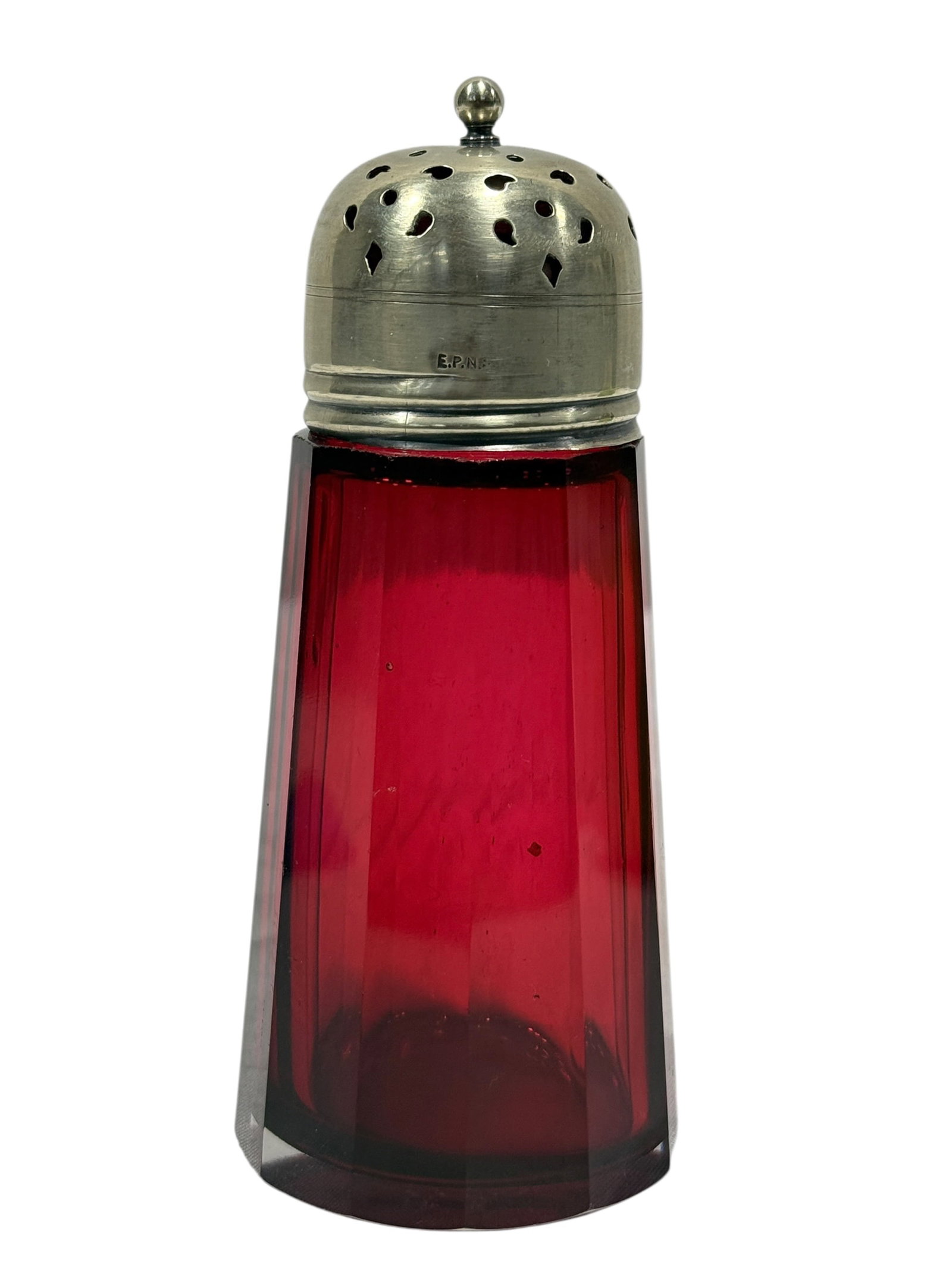 Antique Victorian Paneled Cranberry Glass Sugar Shaker: An antique Victorian-era sugar shaker (muffineer) or large condiment caster featuring a vibrant, transparent cranberry glass body. The glass is blown and shaped into a multi-sided, faceted twelve-pane