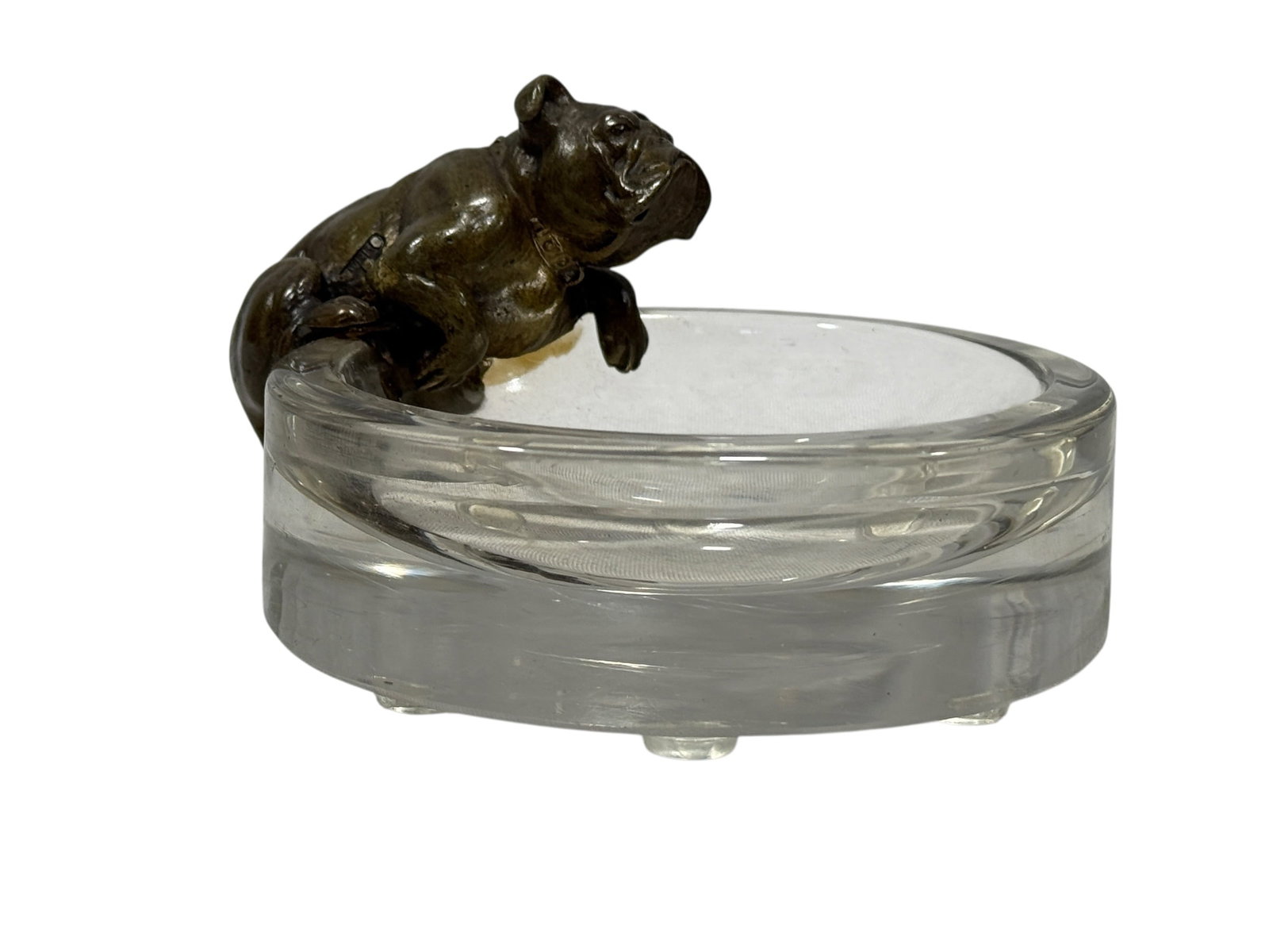 Early 20th Century French Bronze Bulldog and Crystal Ashtray: Charming early 20th-century French figural ashtray combining a finely modeled patinated bronze bulldog with a substantial circular clear crystal or heavy glass dish. The stocky bulldog crouches attent