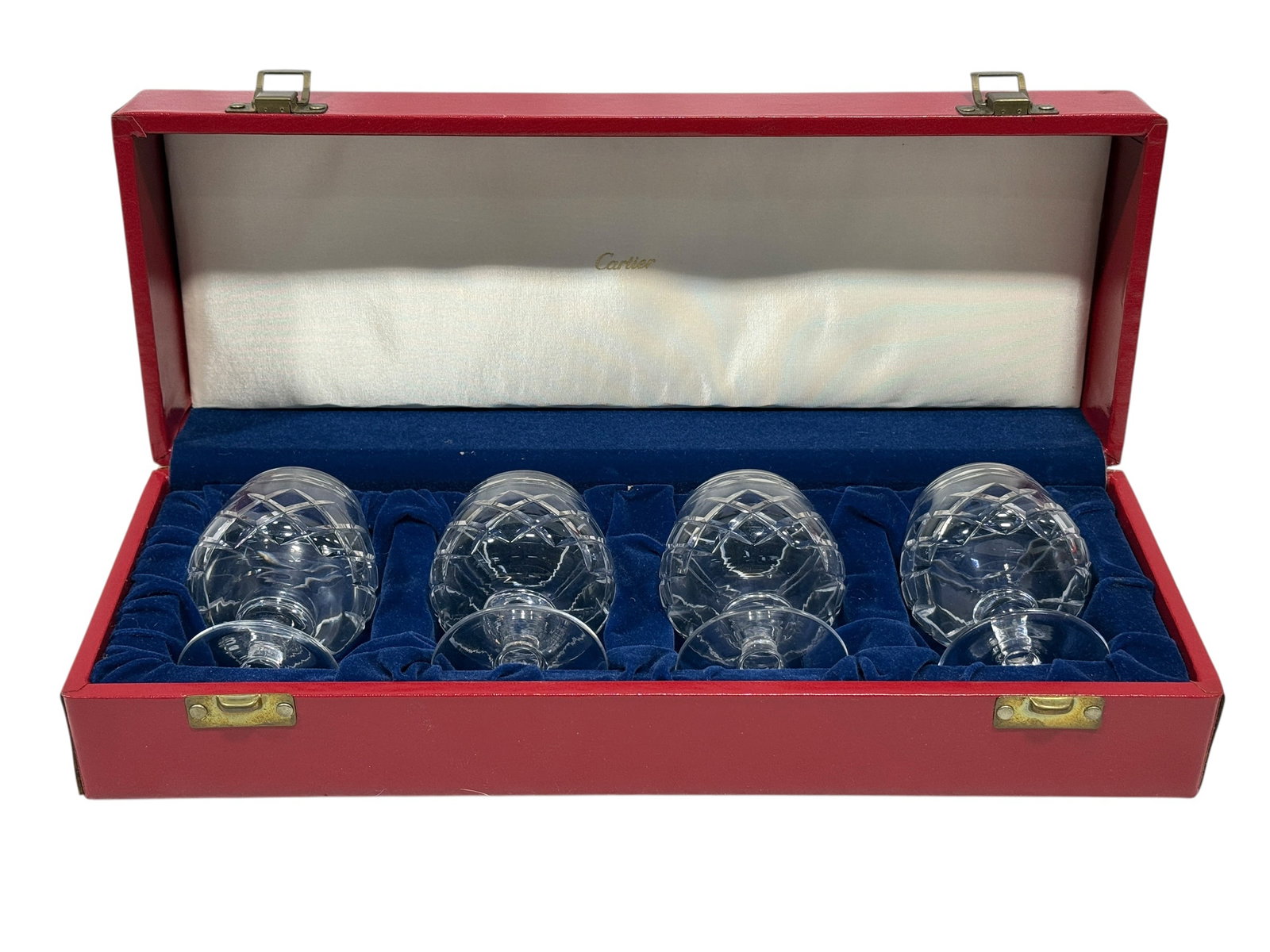 Cartier & Tudor England Set of Four Cut Crystal Brandy Snifters in Cartier Presentation Case: Set of four finely cut crystal brandy snifters of rounded balloon form, each raised on a short faceted stem and circular foot and decorated with an elegant diamond-cut lattice pattern that catches and