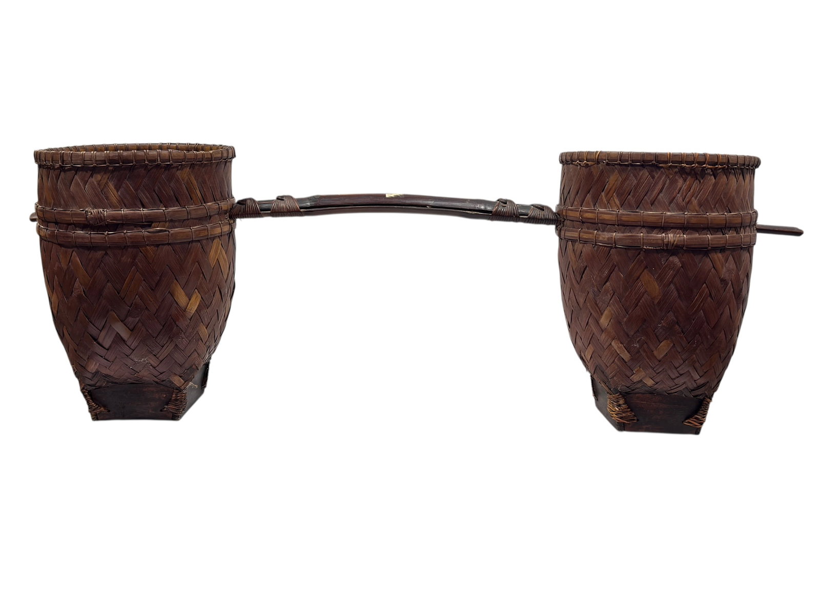 Antique Southeast Asian Woven Bamboo Shoulder Yoke & Baskets: This is an antique Southeast Asian carrying set consisting of two woven bamboo baskets connected by a central wooden shoulder yoke. The baskets feature a wide, circular rim that tapers downward into a