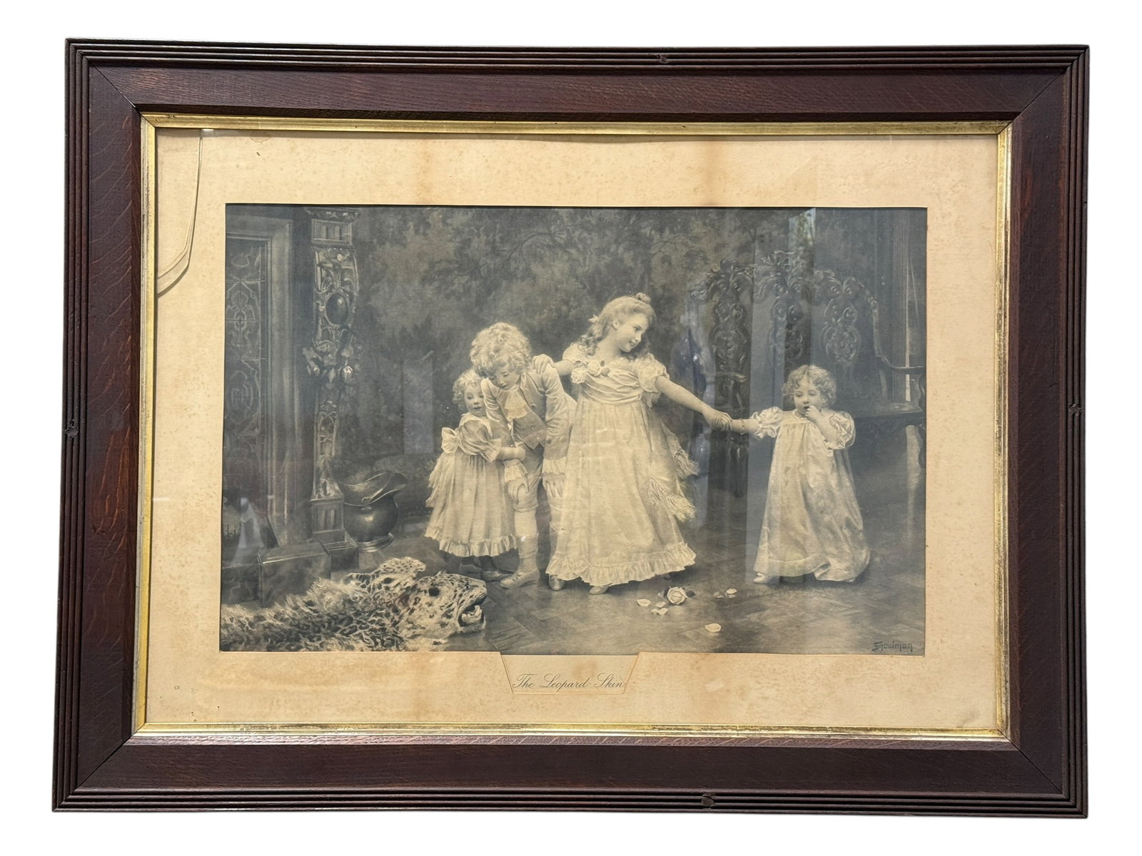 Circa 1903 Large Framed "The Leopard Skin" Victorian Print After Isaac Snowman: Large early 20th-century framed black-and-white print titled The Leopard Skin, after British artist Isaac Snowman, presenting a charming Victorian interior scene in which four elaborately dressed chil