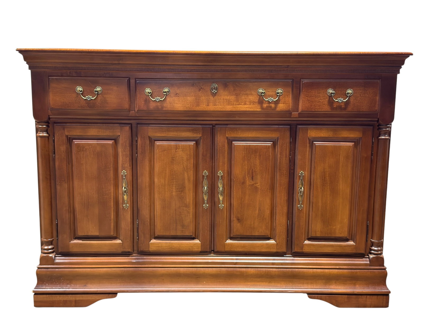 Sumter Cabinet Co. Traditional Walnut-Finish Sideboard: American traditional-style sideboard or buffet by Sumter Cabinet Co. of Sumter, South Carolina, constructed in a warm medium walnut-toned finish with a broad molded top, dentil-style trim beneath the 
