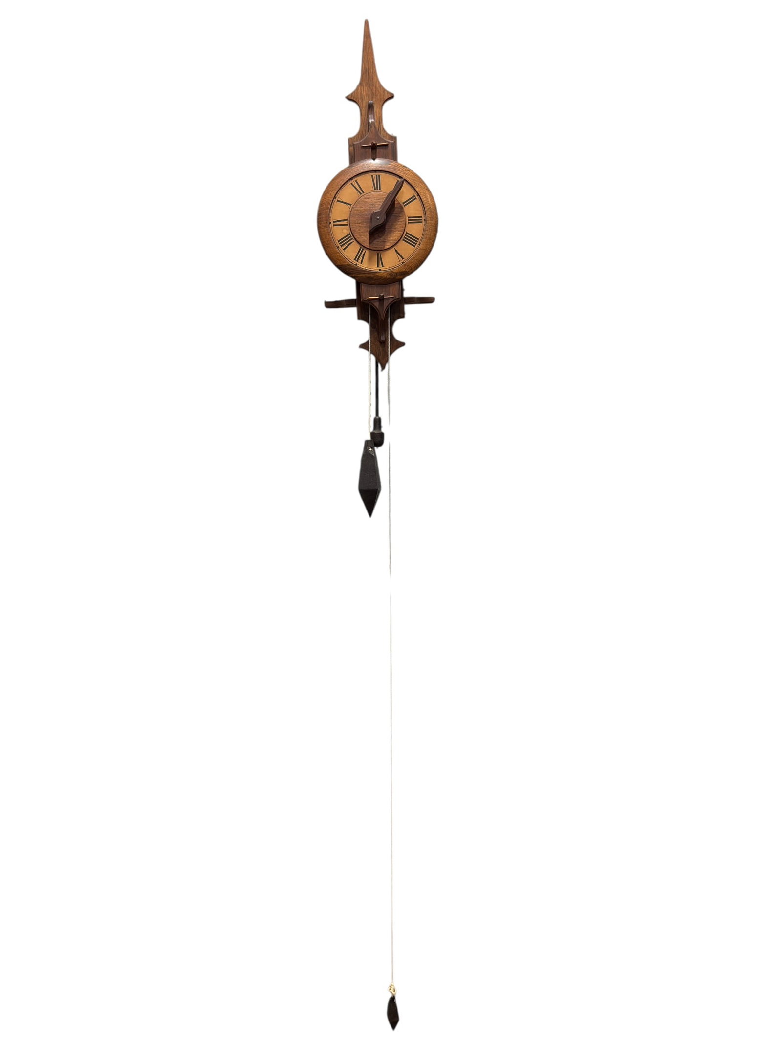Jofecor Brazilian Mid-20th Century Wood Weight-Driven Wall Clock: Jofecor Brazilian weight-driven wall clock, mid-20th century, constructed in richly grained hardwood and designed in a stylized traditional form with a tall spear-point crest, architectural crosspiece