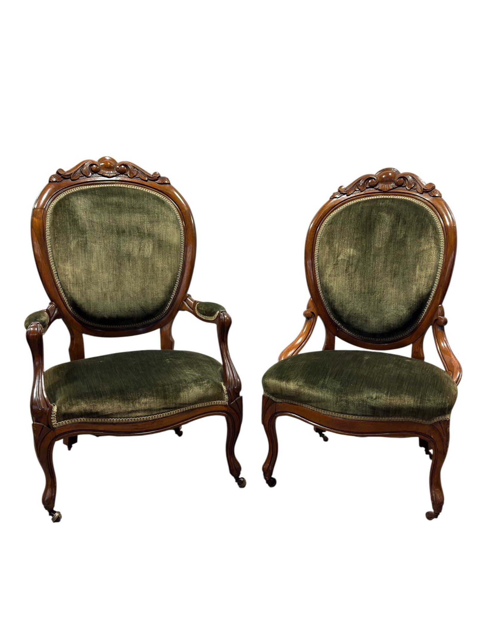 Pair of Late 19th Century Victorian Walnut Rococo Revival Parlor Armchairs: Pair of handsome late 19th-century Victorian walnut parlor armchairs in the Rococo Revival taste, each with a broad oval upholstered back framed by richly molded walnut and surmounted by an exuberantl