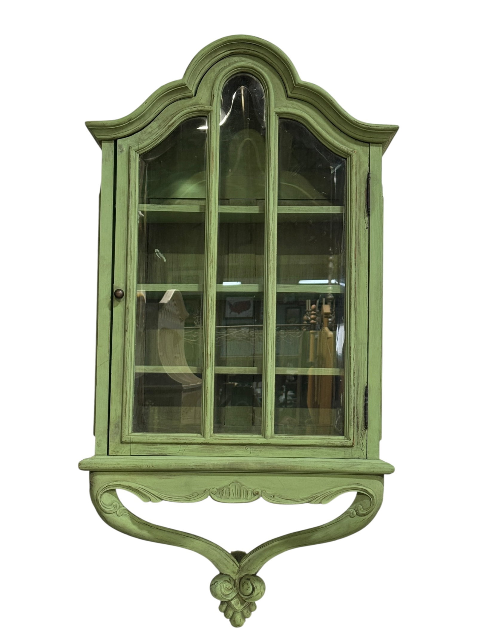 Vintage French Provincial Style Wall Curio Cabinet: Charming vintage French Provincial-style wall-mounted display cabinet or vitrine, crafted in wood and finished in a soft celadon or pale mint-green painted surface with gently distressed character. Th