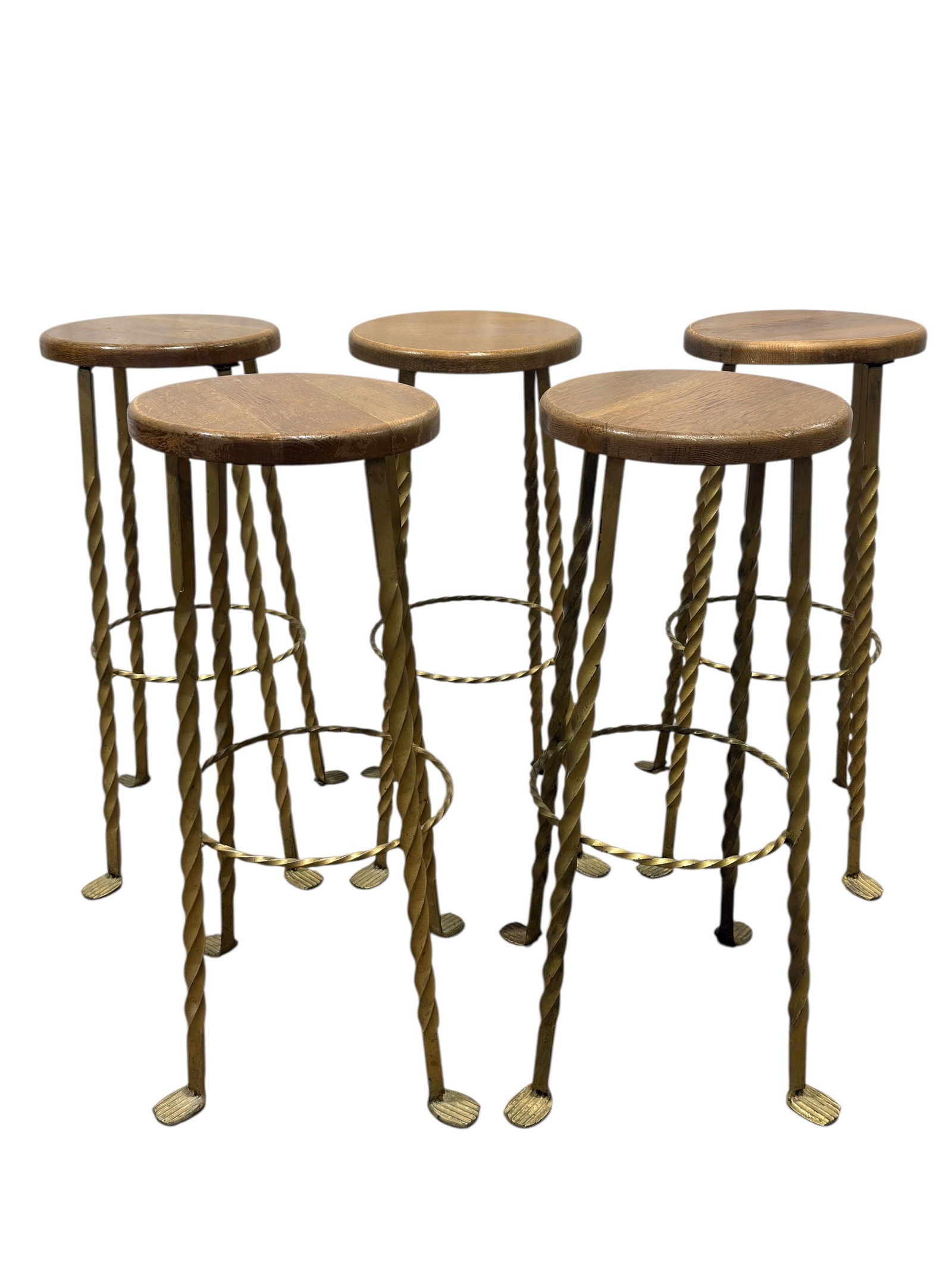 5 French Style Oak & Gilt Wrought Iron Bar Stools: Set of five vintage bar-height stools combining warm circular oak seats with decorative gilt-finished wrought iron bases, each raised on four slender spiraled or barley-twist supports joined by a circ