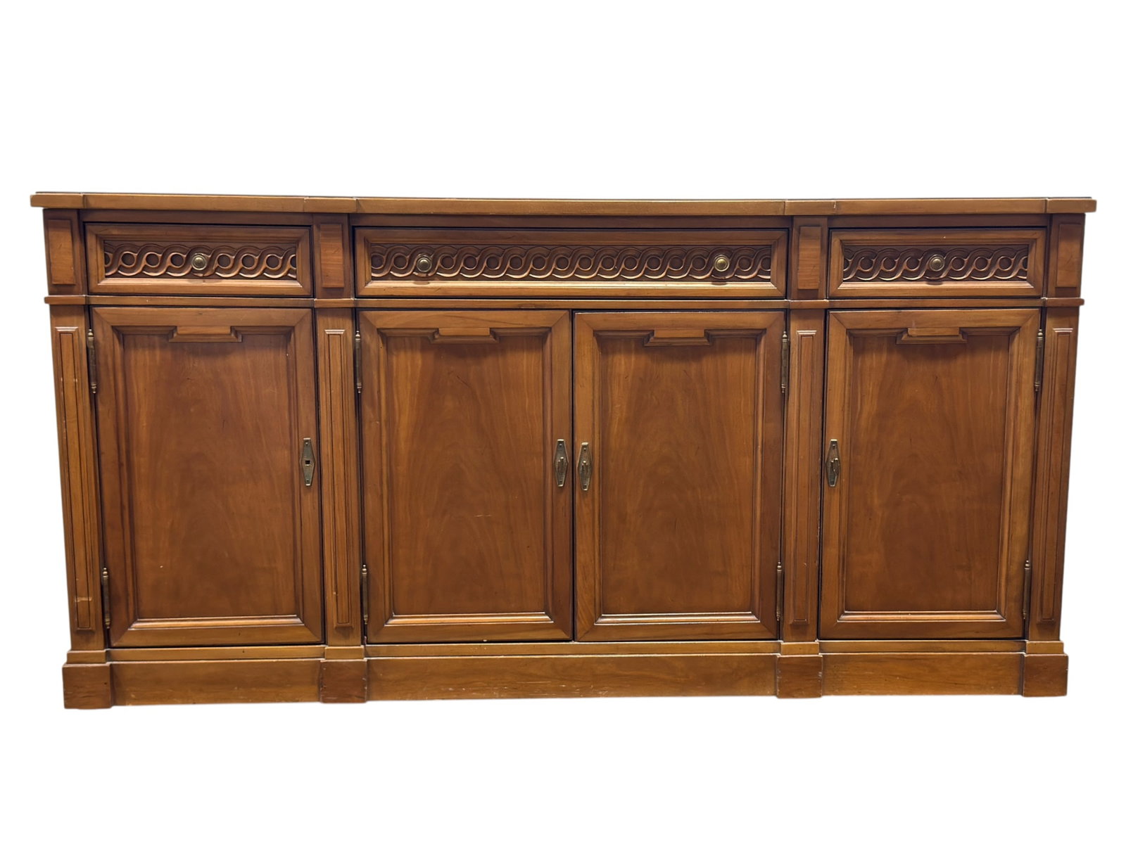 Thomasville Vintage Carved Wood Sideboard: Vintage Thomasville sideboard or buffet credenza, crafted in warm medium-toned wood with a long rectangular top, paneled cabinet doors, and handsome carved architectural detailing throughout. The case