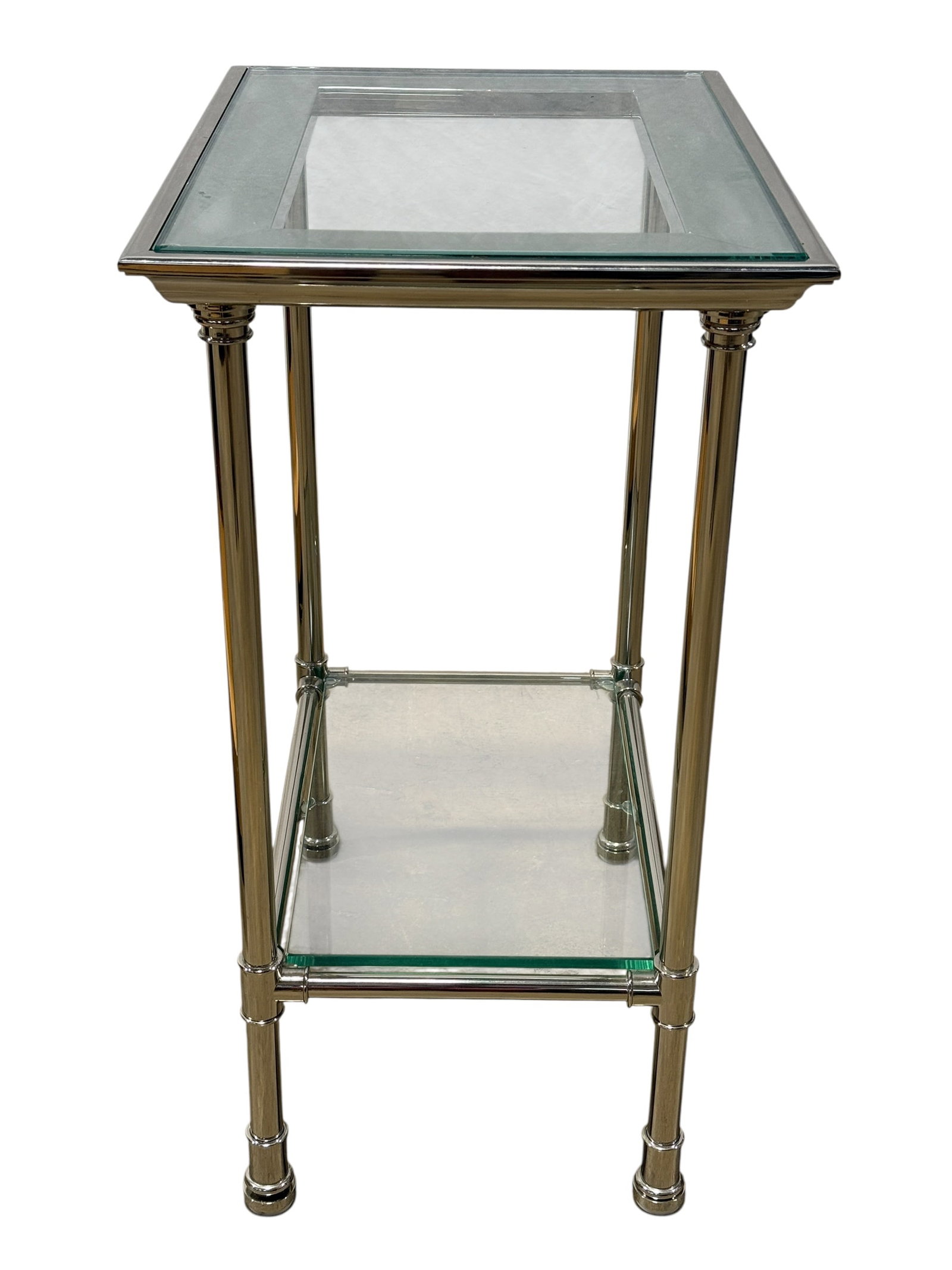 Contemporary Chrome & Glass 2 Tier Accent: Sleek contemporary rectangular side or accent table constructed with a polished chrome-finished metal frame supporting a thick clear glass top and a coordinating lower glass shelf. Four slender cylind