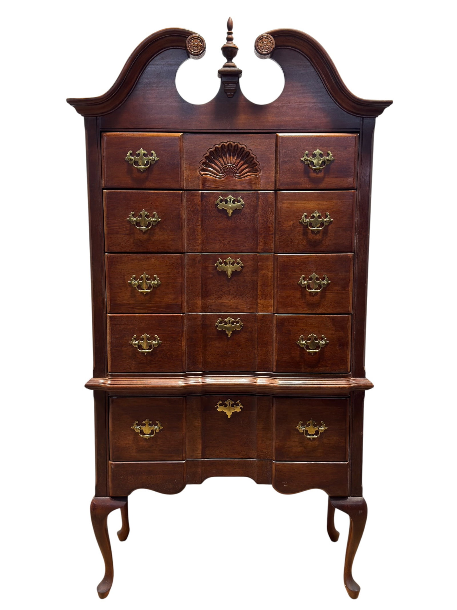 20th Century Chippendale Style Mahogany Highboy Chest: A substantial 20th-century Chippendale-style mahogany highboy or tall chest of drawers, designed in the Colonial Revival tradition with an imposing broken-scroll bonnet pediment, carved circular roset