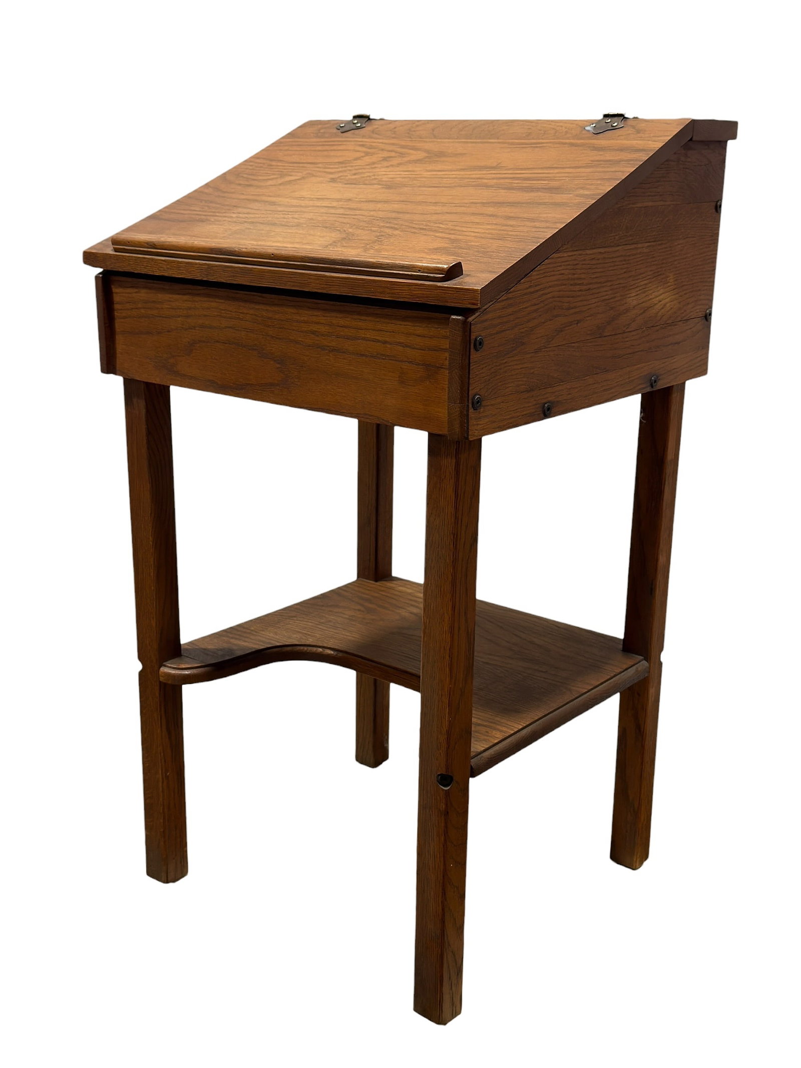 20th Century Oak Schoolmaster Style Lift Top Writing Desk: A handsome 20th-century schoolmaster-style standing writing desk, constructed in richly grained oak with a warm medium-brown finish and a practical, traditional form inspired by antique schoolhouse an