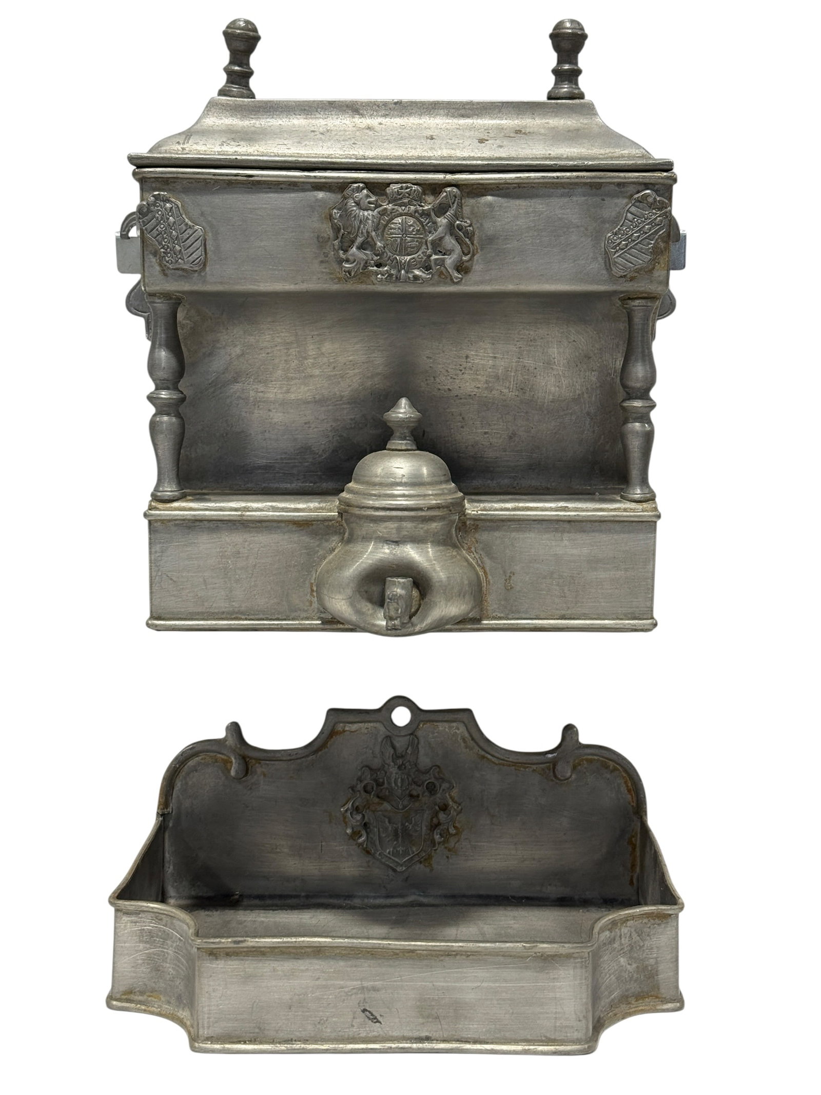 Antique Pewter Wall Mounted Lavabo Water Cistern & Wash Basin Set: A striking old-world wall-mounted lavabo set, designed with the architectural presence of a miniature furnishing and richly embellished with heraldic relief decoration throughout. The upper cistern is